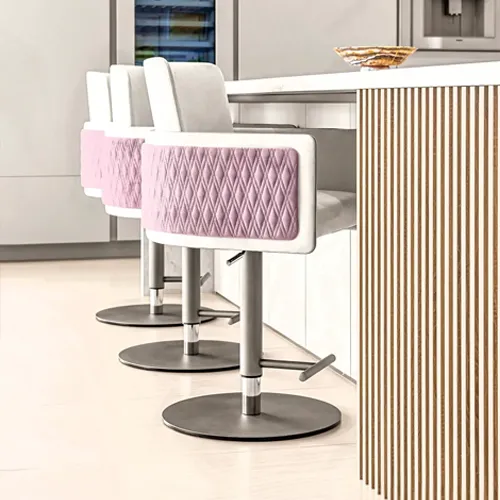 Three modern bar stools with light purple quilted backs positioned at a white kitchen island with vertical wooden slats.