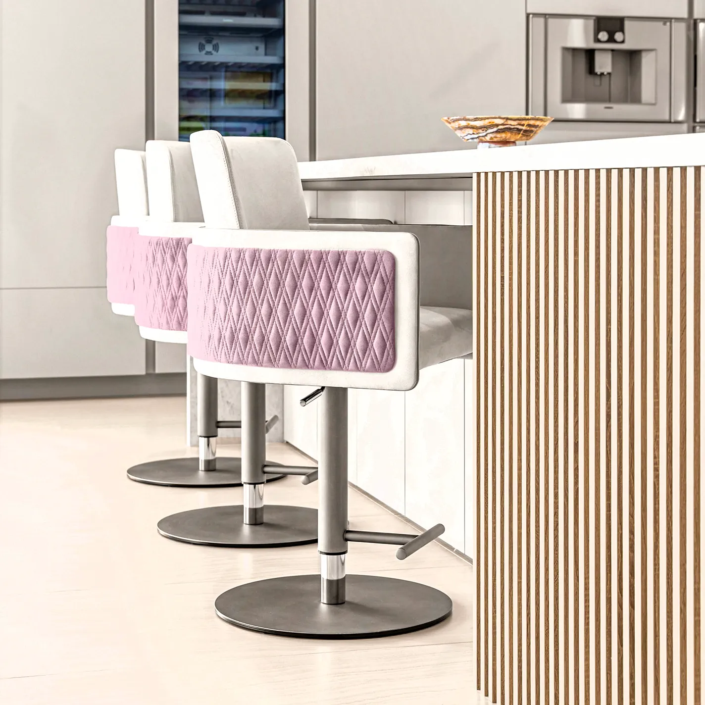 personalized-condo-from-top-to-bottom-case-study-10 A modern kitchen with a white marble island, three pink quilted bar stools, integrated stainless steel appliances, and a fluted wood island base.