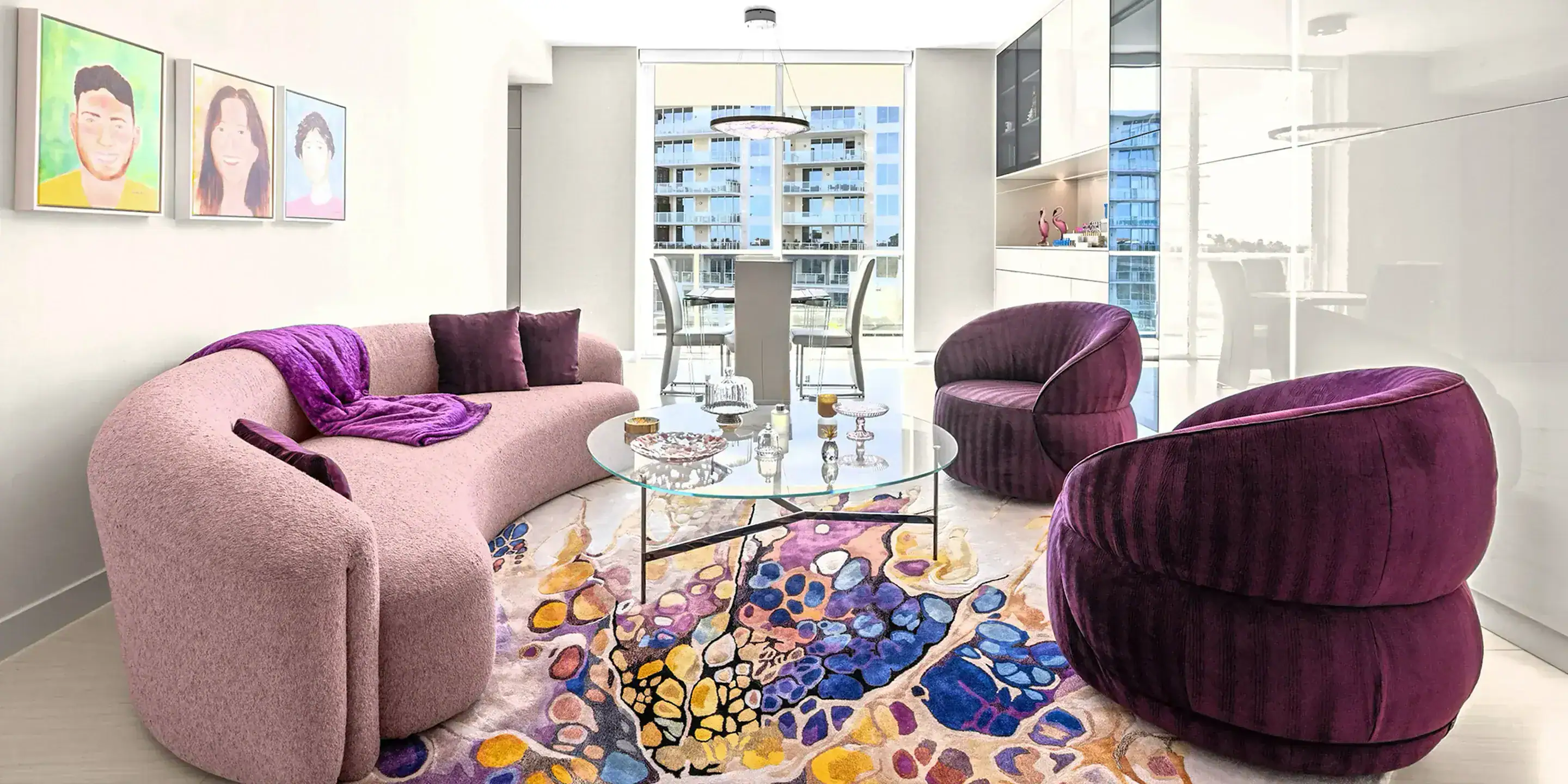 personalized-condo-from-top-to-bottom-case-study-2.2 Elegant pink sofa with purple cushions and throw in a contemporary condo living room.