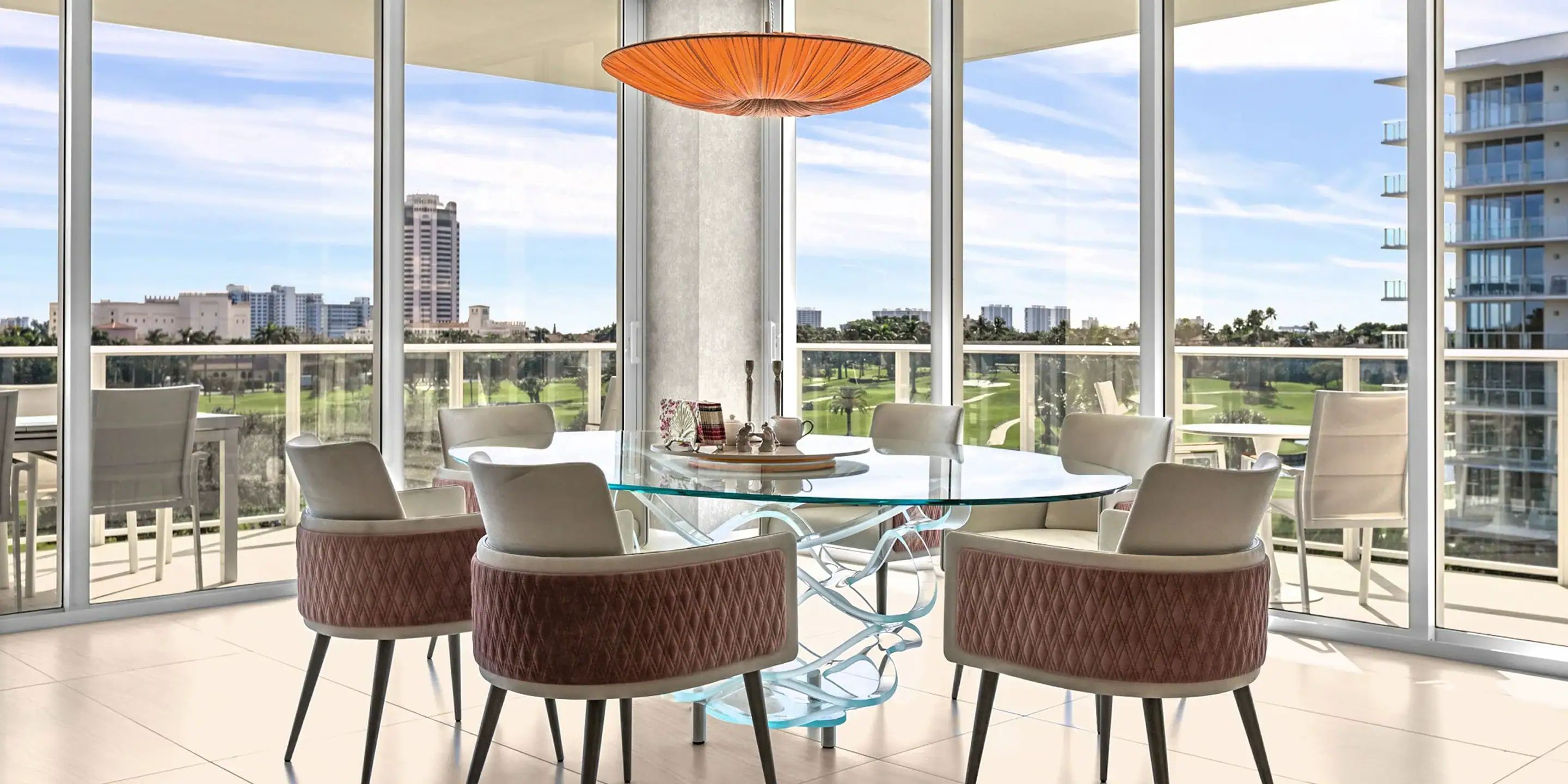 Contemporary condo dining space featuring elegant furniture and large windows showcasing cityscape v.