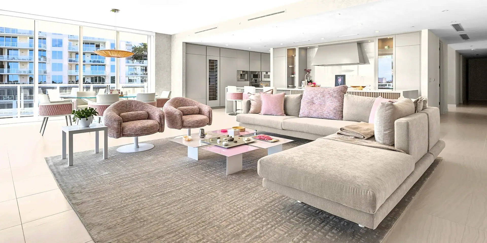 Bright, spacious condo living room with large windows and contemporary furniture.