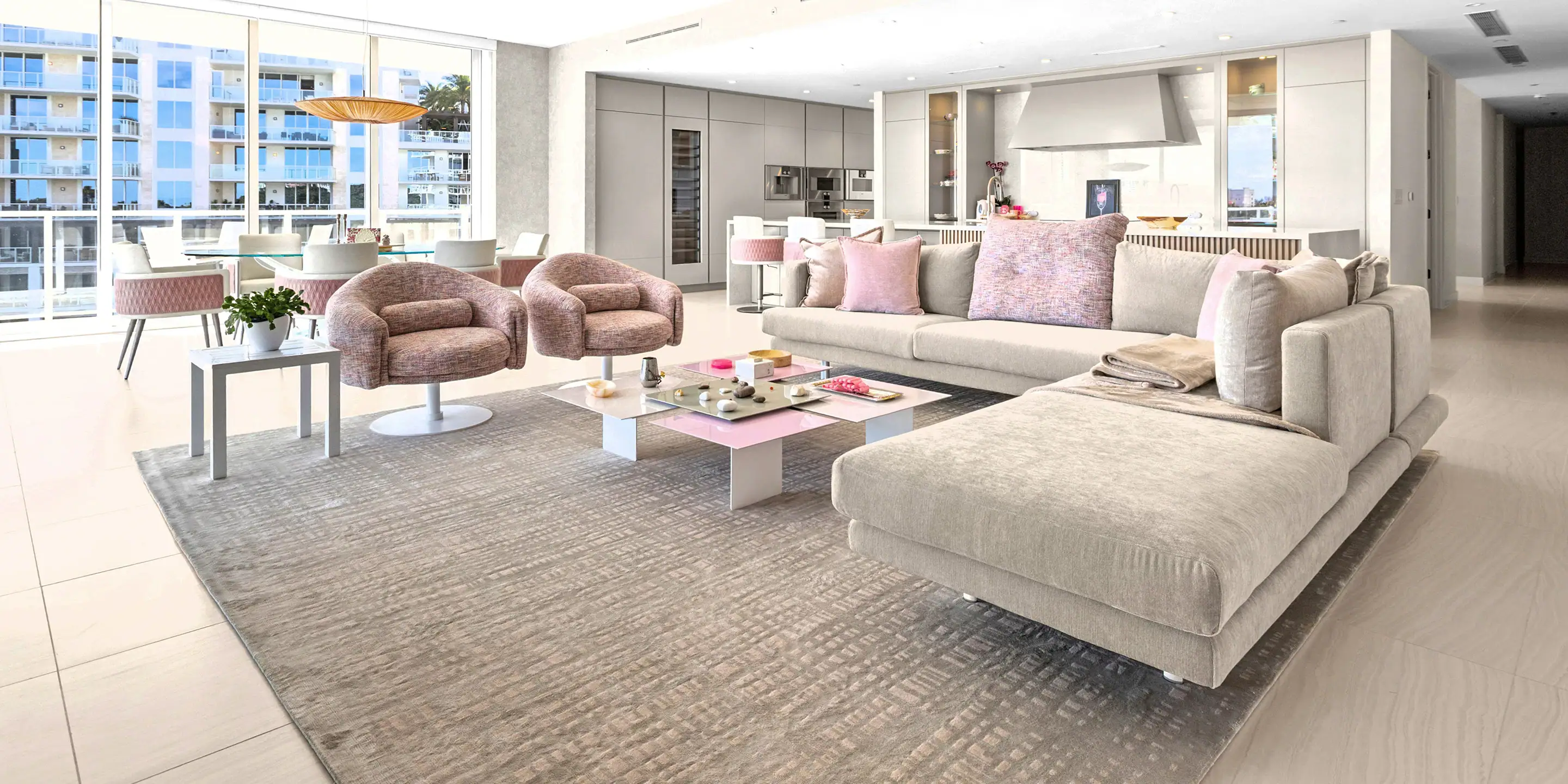 Bright, spacious condo living room with large windows and contemporary furniture.