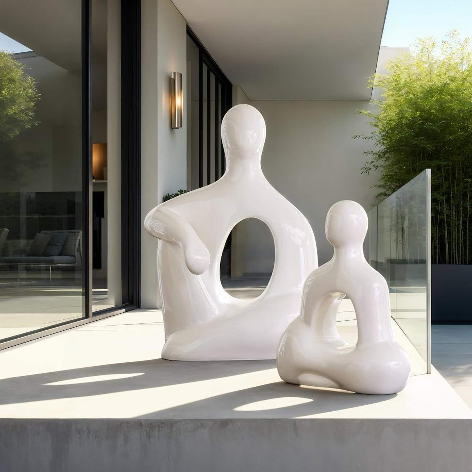 White abstract art sculpture on patio, modern outdoor decor, artistic garden sculpture.