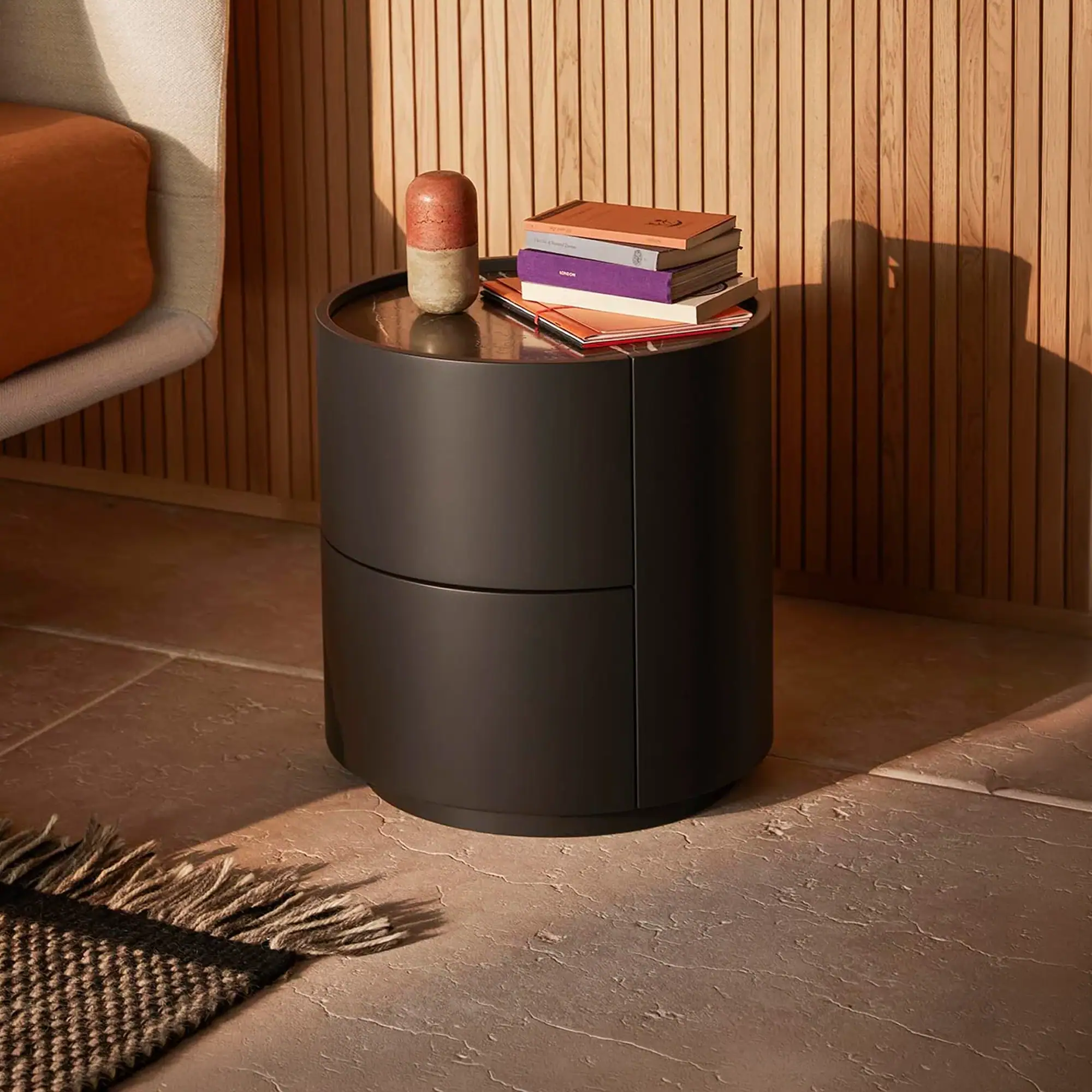 Sklar Furnishings nightstand with books and decorative item on top.
