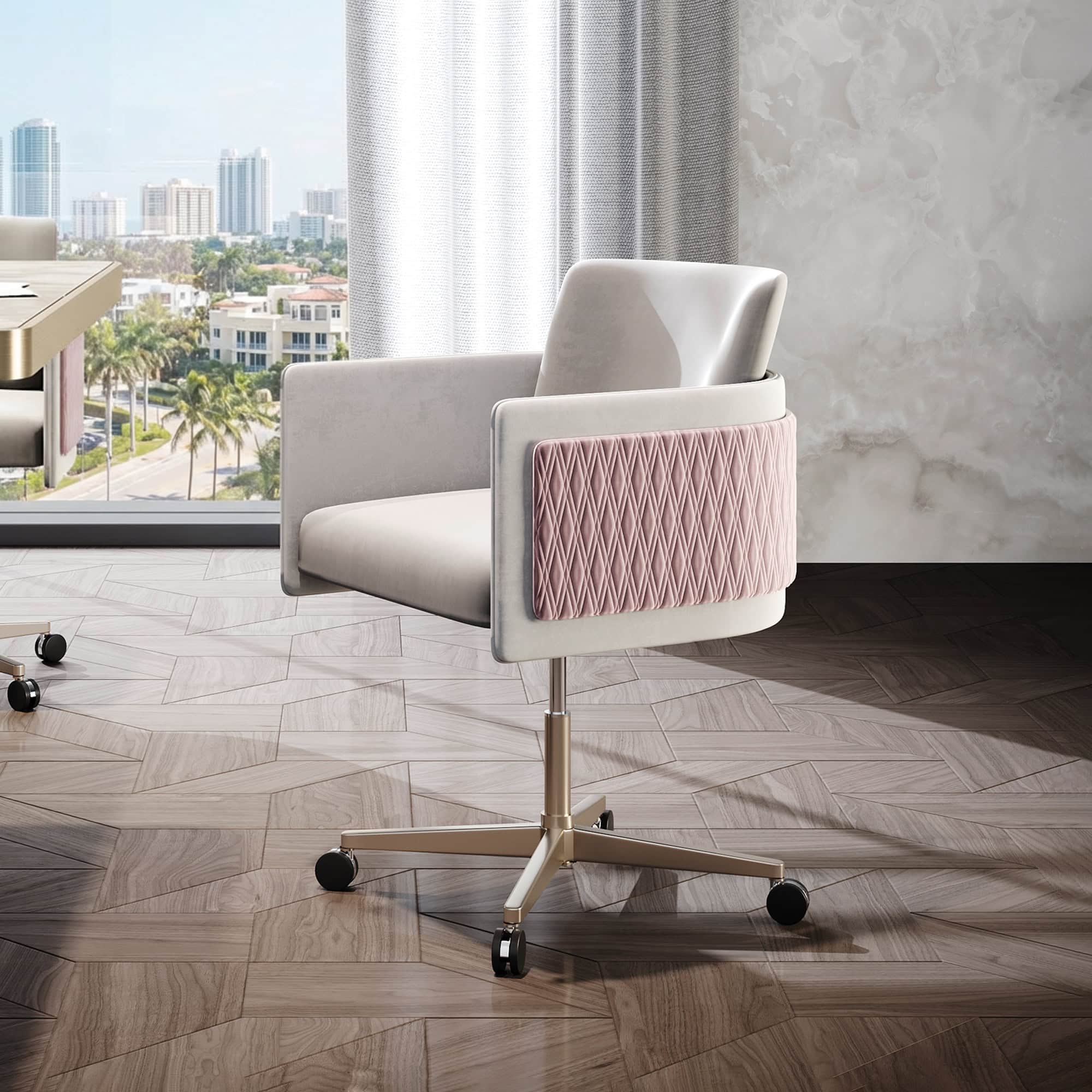 A modern beige velvet office chair with a quilted pink back panel and gold base, positioned in front of a large window overlooking a city skyline.