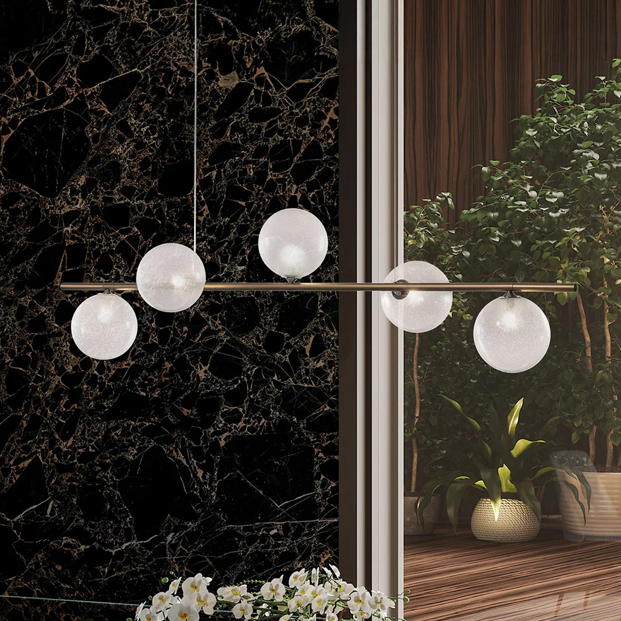 Beautiful contemporary lighting fixture featuring five spherical glass bulbs in an open space.