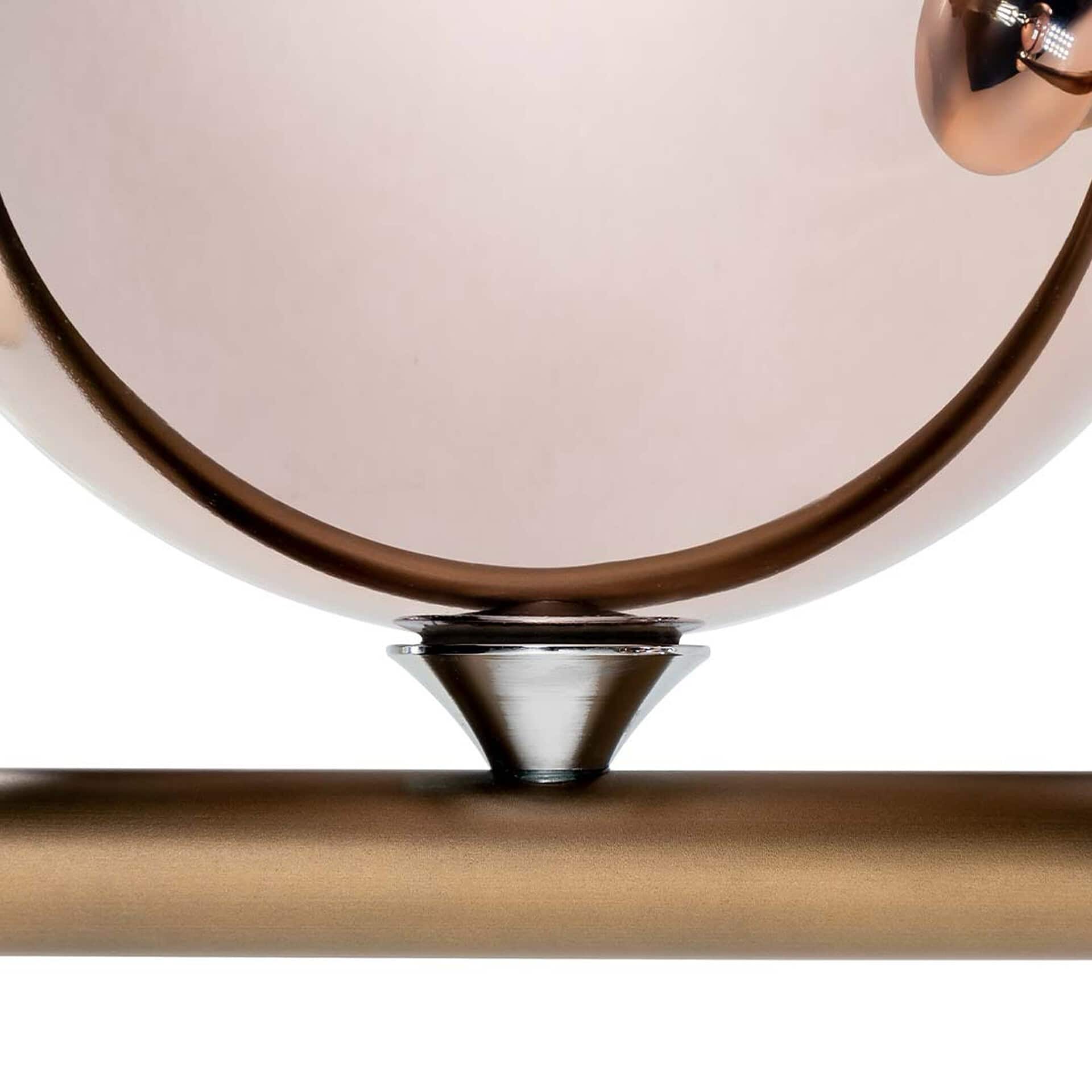 Close-up of a contemporary bronze and metal table lamp emphasizing sleek design and high-quality materials.