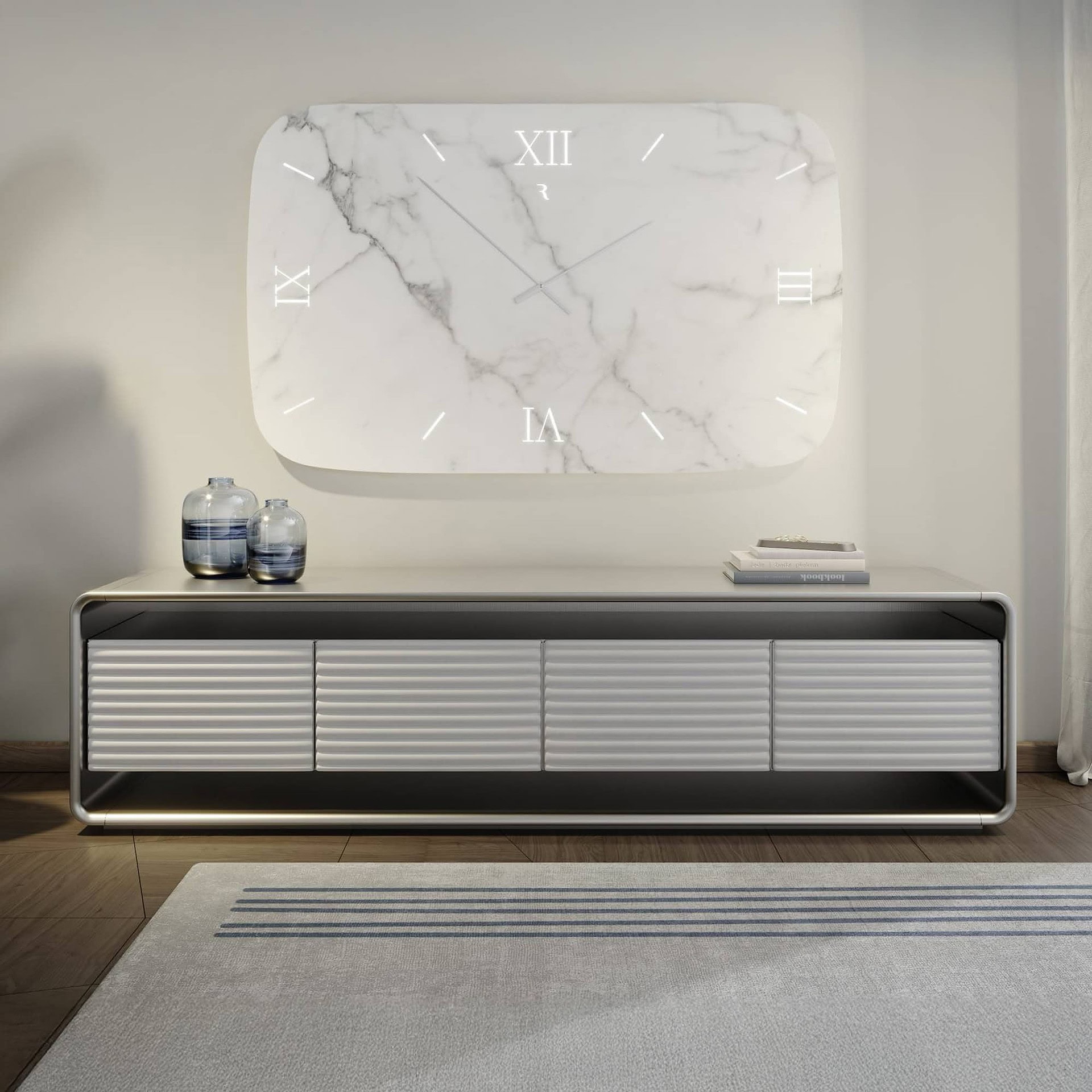 A modern living room with a large, illuminated white marble wall clock above a light grey ribbed media console. Two blue glass vases and a stack of books adorn the console. A light grey rug with blue stripes is on the wooden floor.