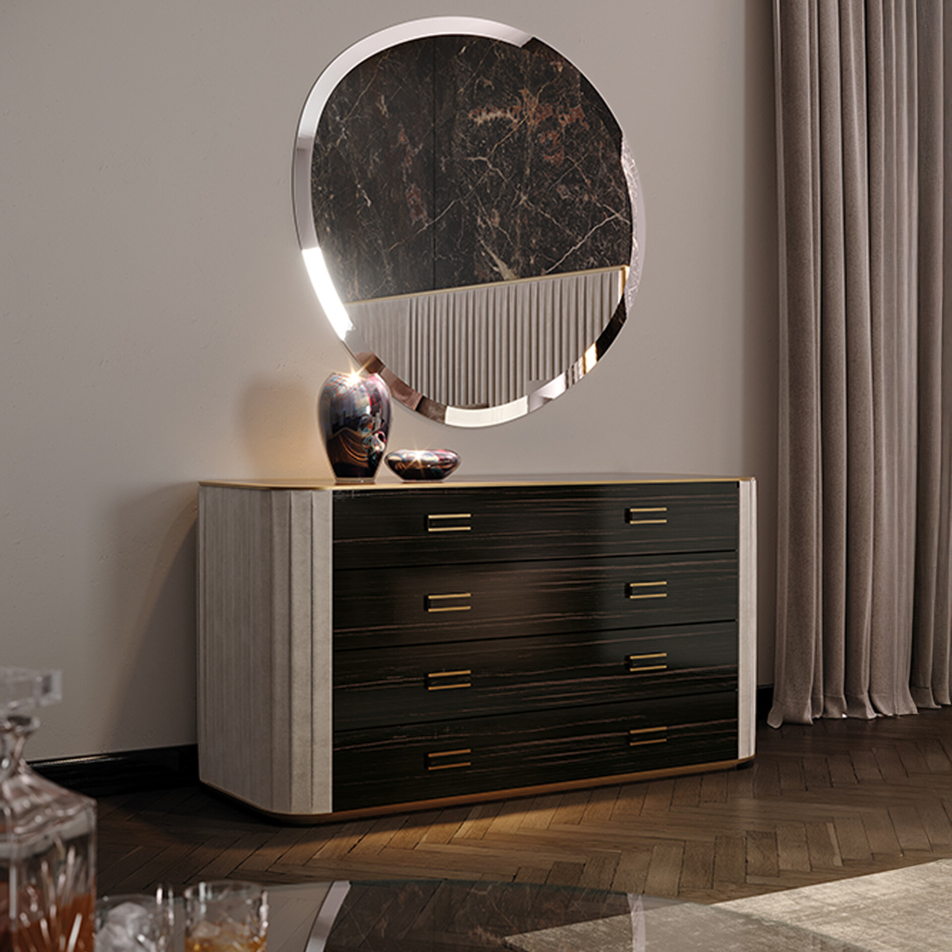 A modern dark wood dresser with gold handles and fluted sides, topped with an iridescent vase and bowl, beneath an irregularly shaped mirror with a marbled and fluted design, set in an elegant room with herringbone wood floor and taupe curtains.