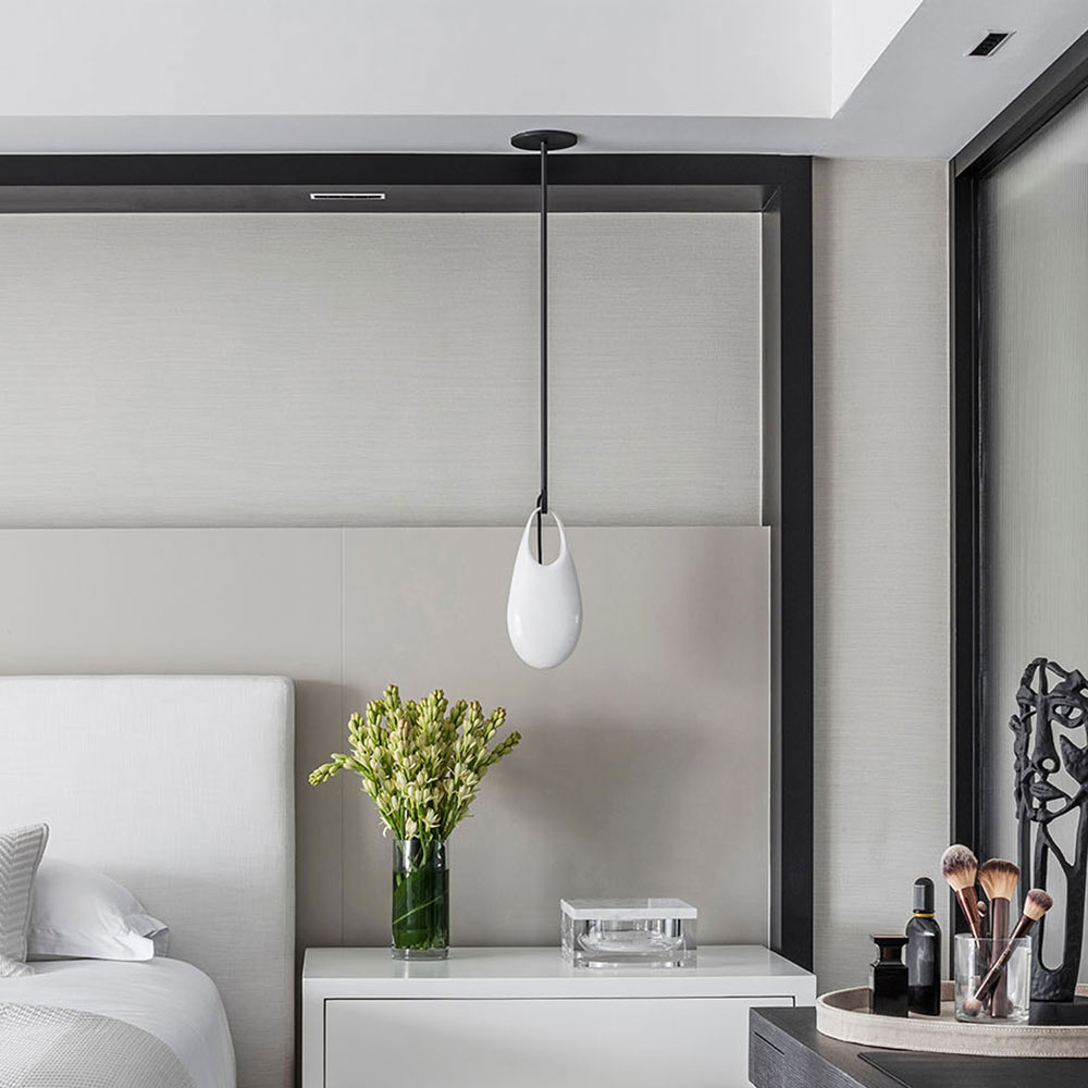 Contemporary bedroom with modern pendant light and sleek decor for stylish living.