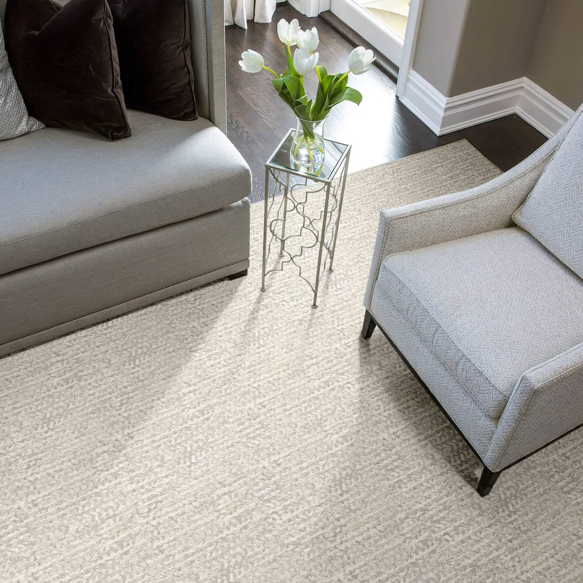 Stylish living room featuring contemporary seating, decorative side table, and fresh tulip arrangement.