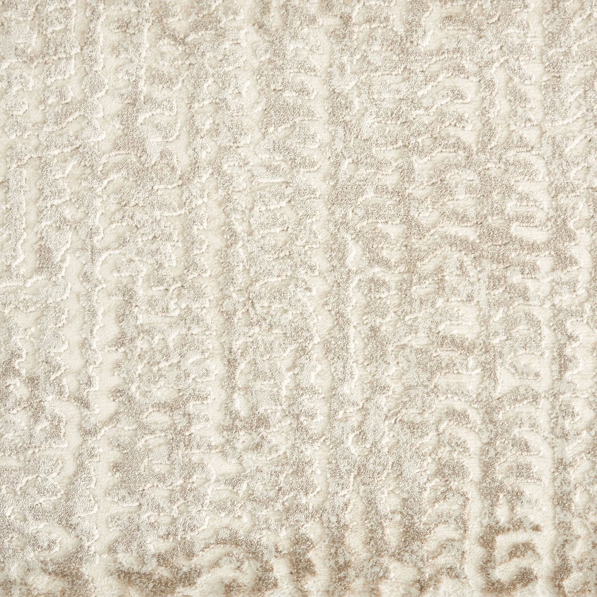 Cream textured rug with intricate patterns for stylish interior decor.