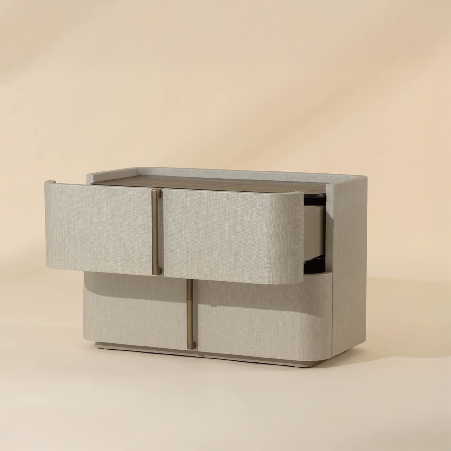 A modern two-drawer nightstand with rounded corners, covered in light textured fabric. It has a dark brown top surface, sleek vertical bronze handles, and the top drawer is slightly open.