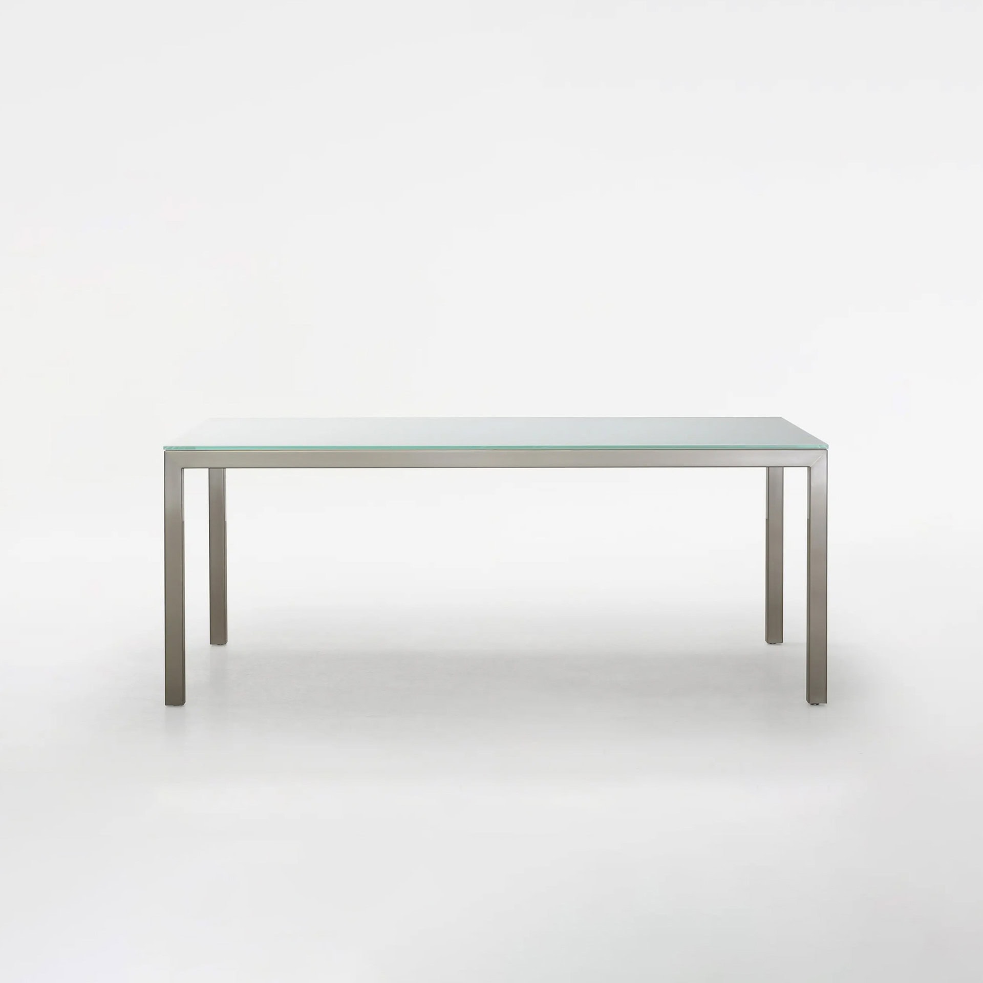 Stainless steel frame with glass top dining table.