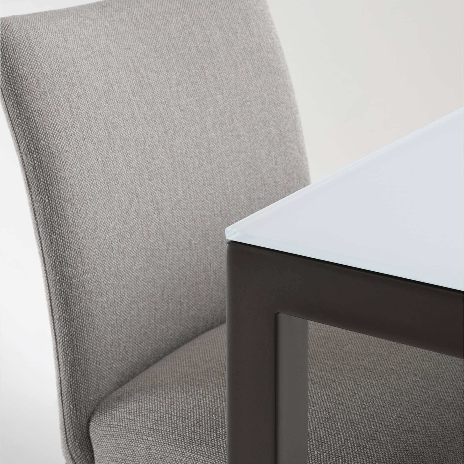 Stylish upholstered dining chair with fabric cover and black metal base.