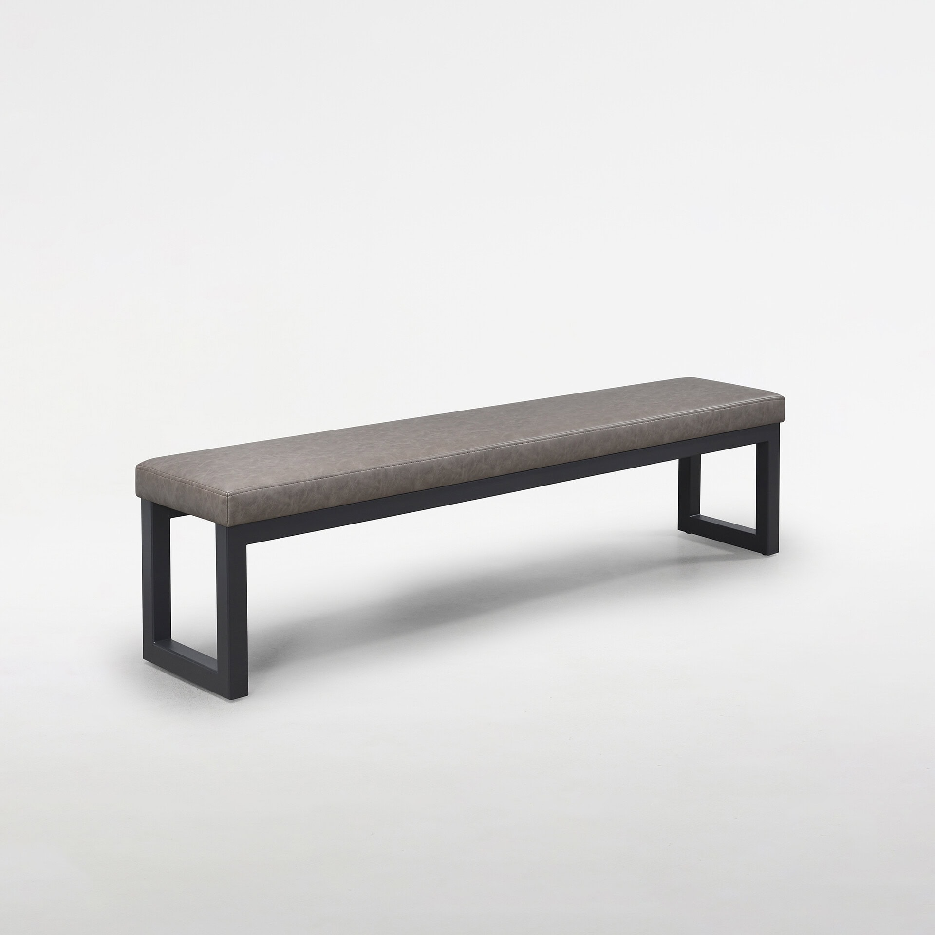 A modern gray upholstered bench with a black metal frame on a white background.