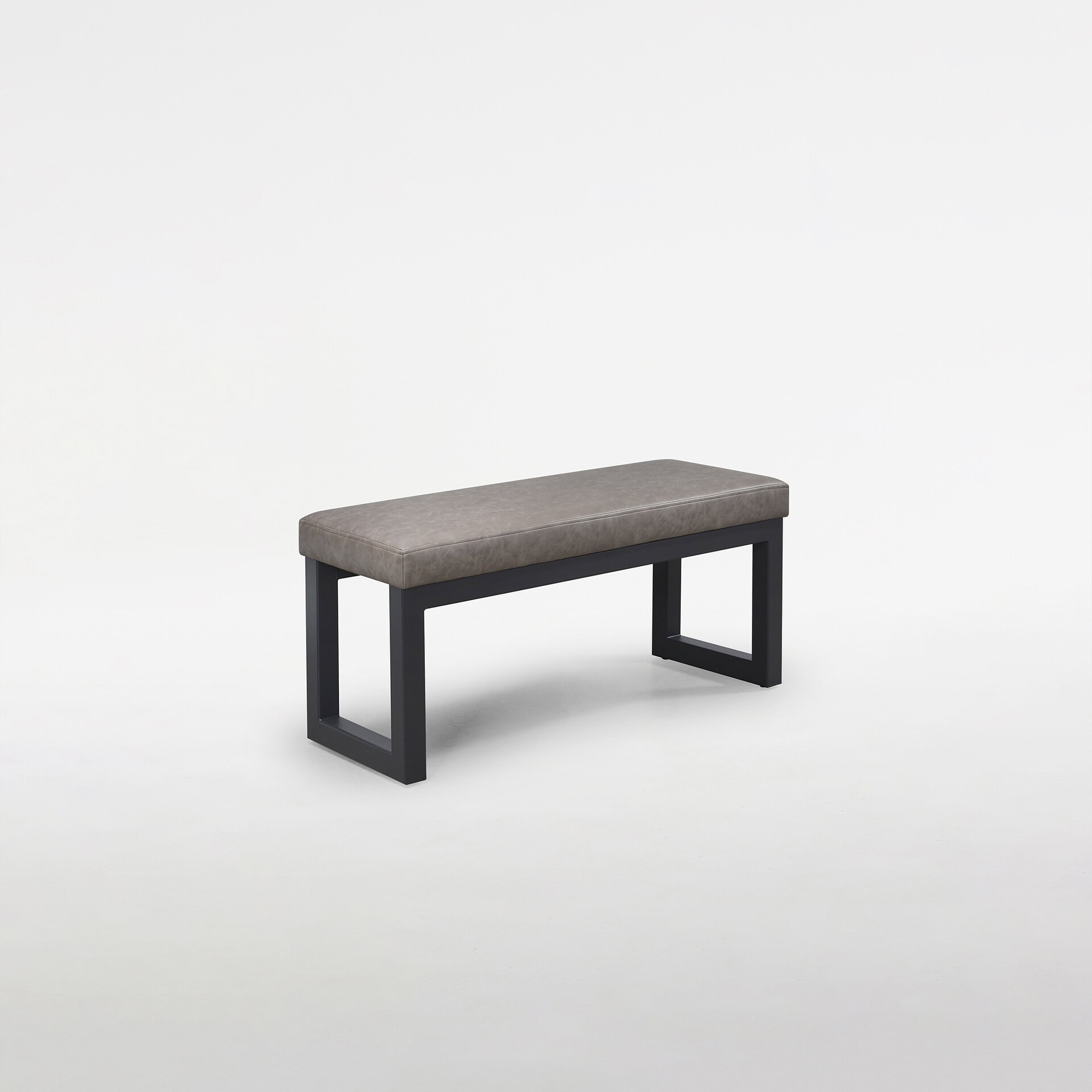 A modern gray upholstered bench with a black metal frame, shown at an angle on a white background.
