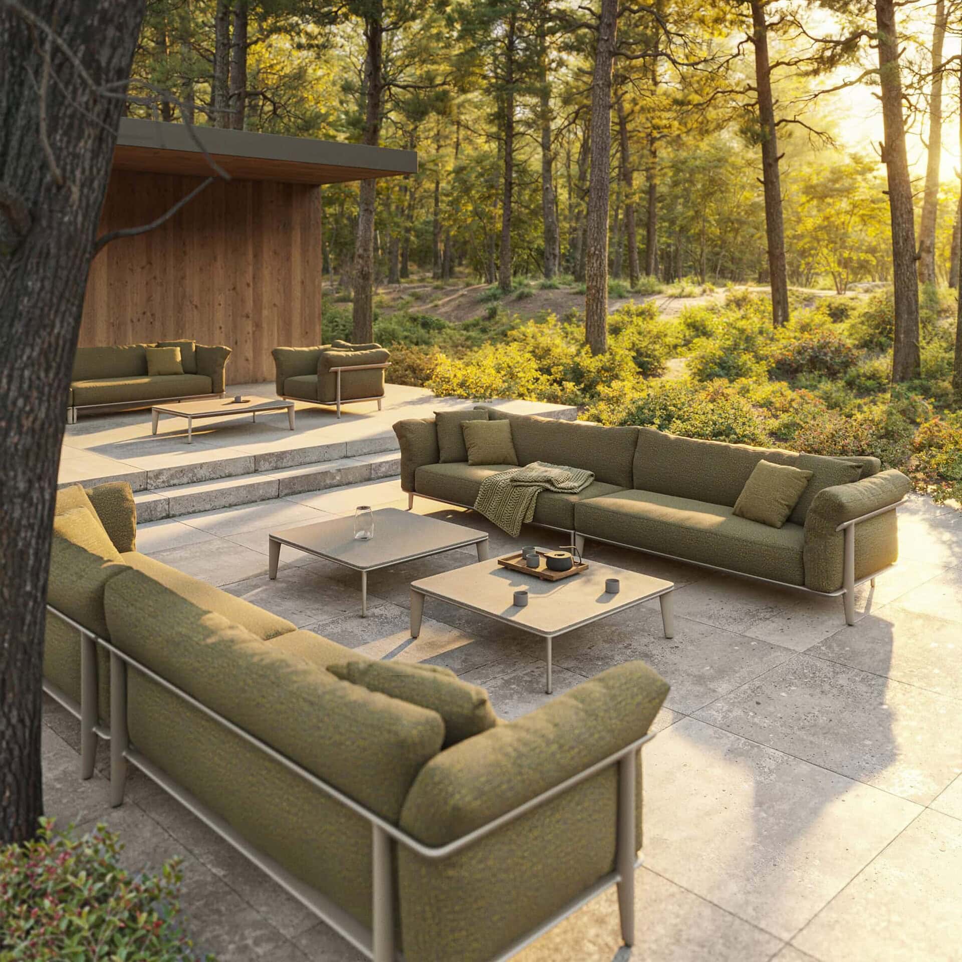 Stylish outdoor furniture set from Sklar Furnishings in a serene forest setting.