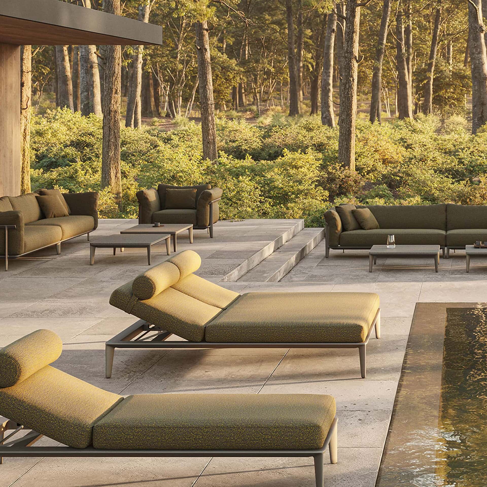 Luxurious modern outdoor furniture set by Sklar Furnishings on patio with forest view.