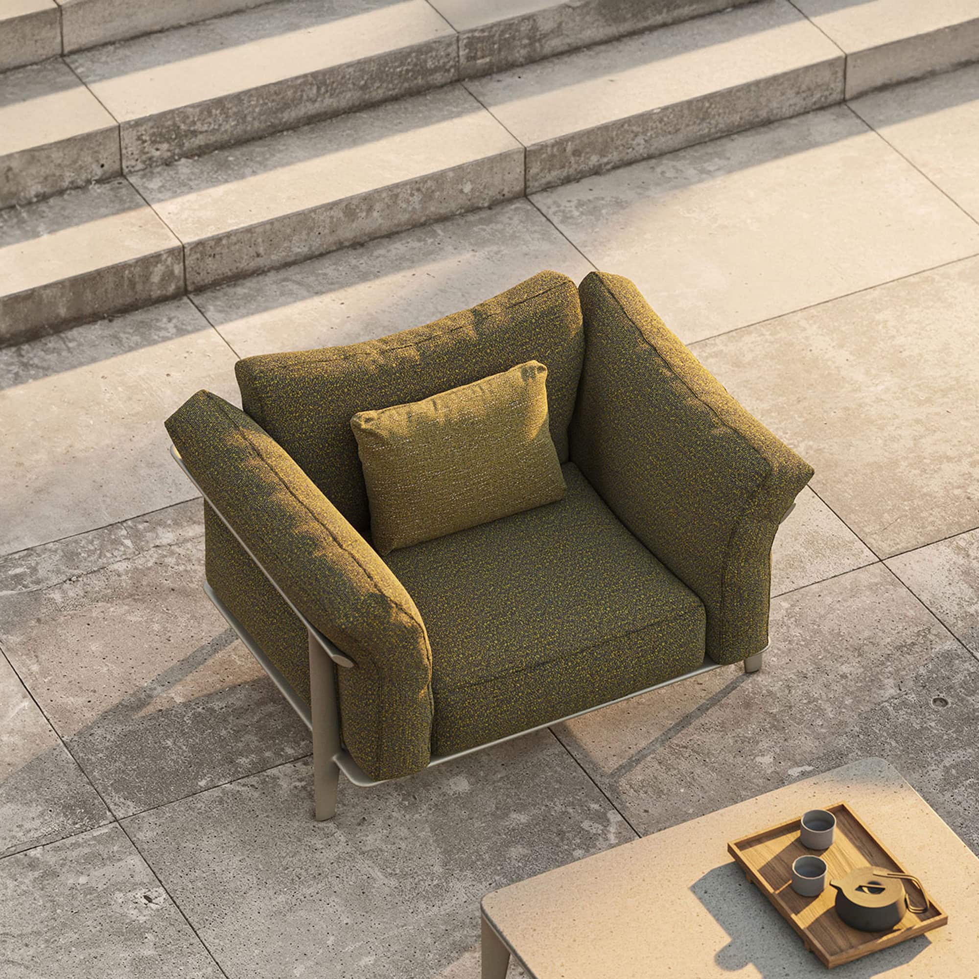 Stylish green upholstered armchair with modern design and metal legs from Sklar Furnishings.