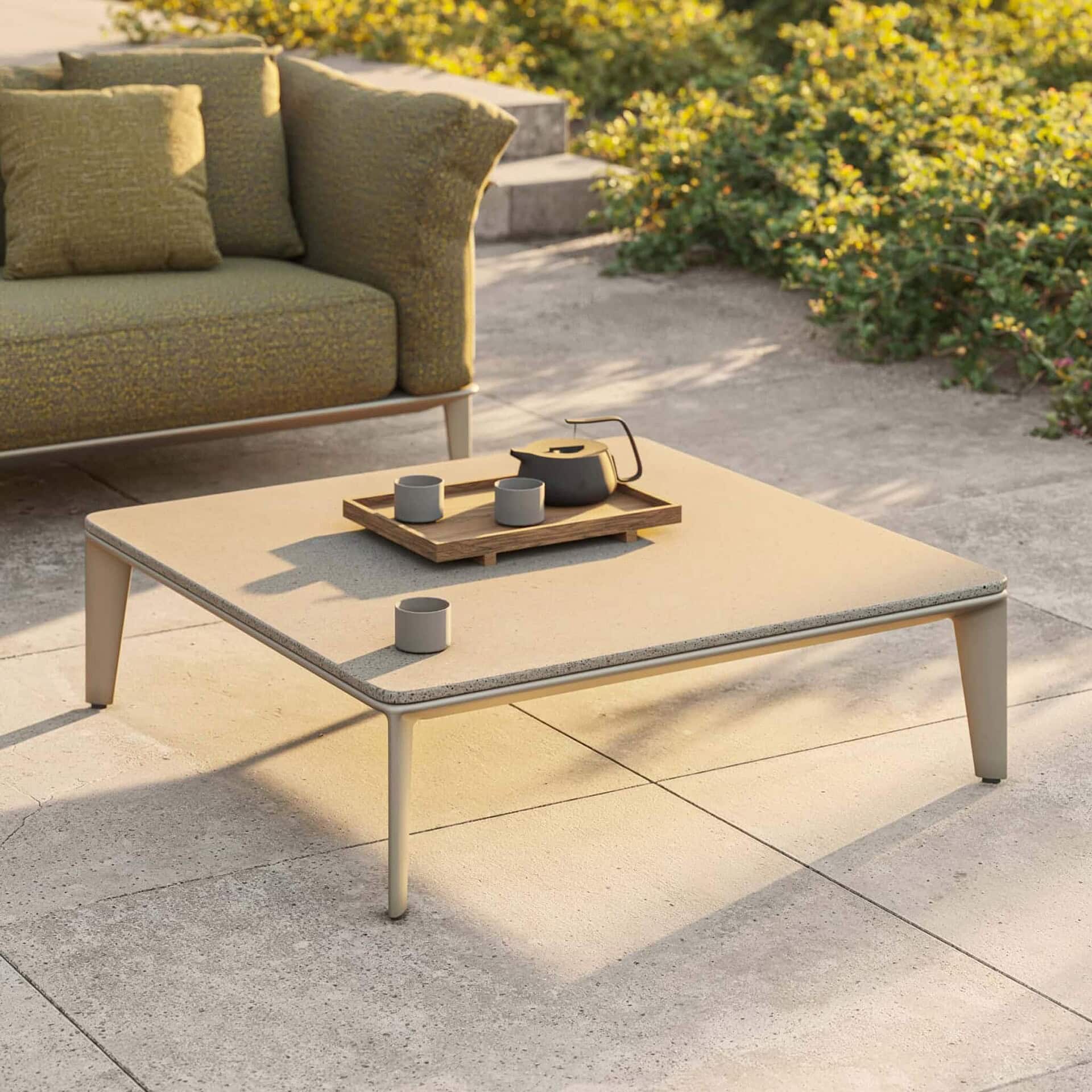 Minimalist outdoor coffee table with textured surface and sleek design.