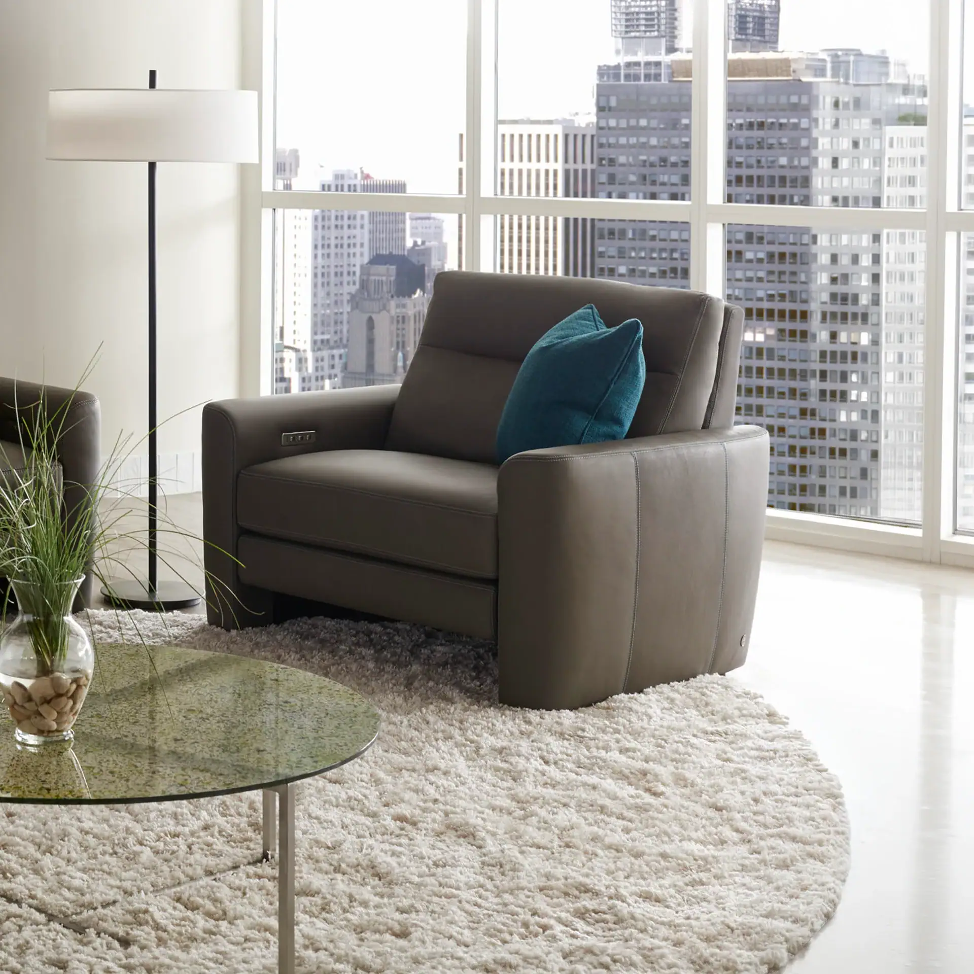 Armchair with sleek leather finish and plush cushion, ideal for contemporary living spaces.