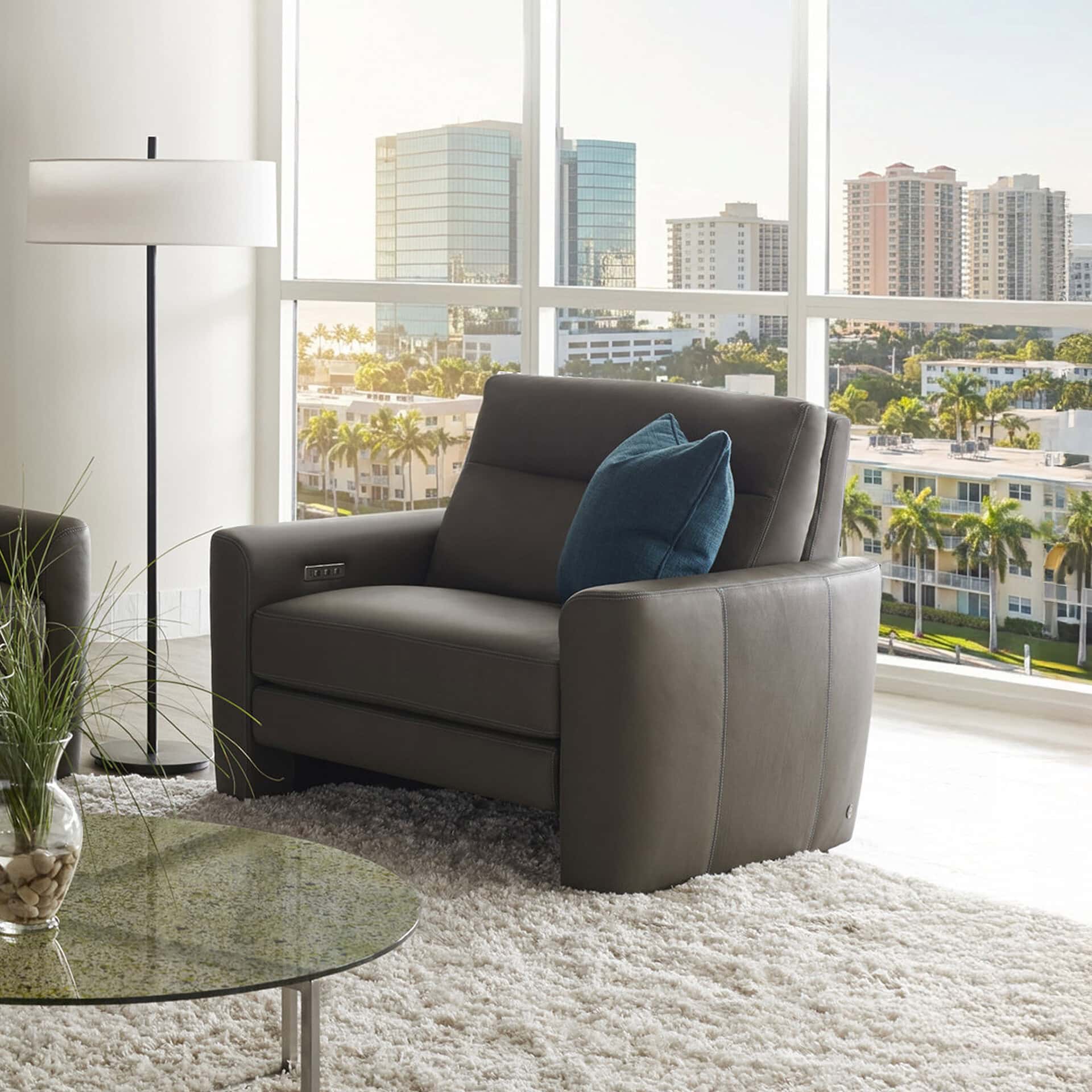 Armchair with sleek leather finish and plush cushion, ideal for contemporary living spaces.