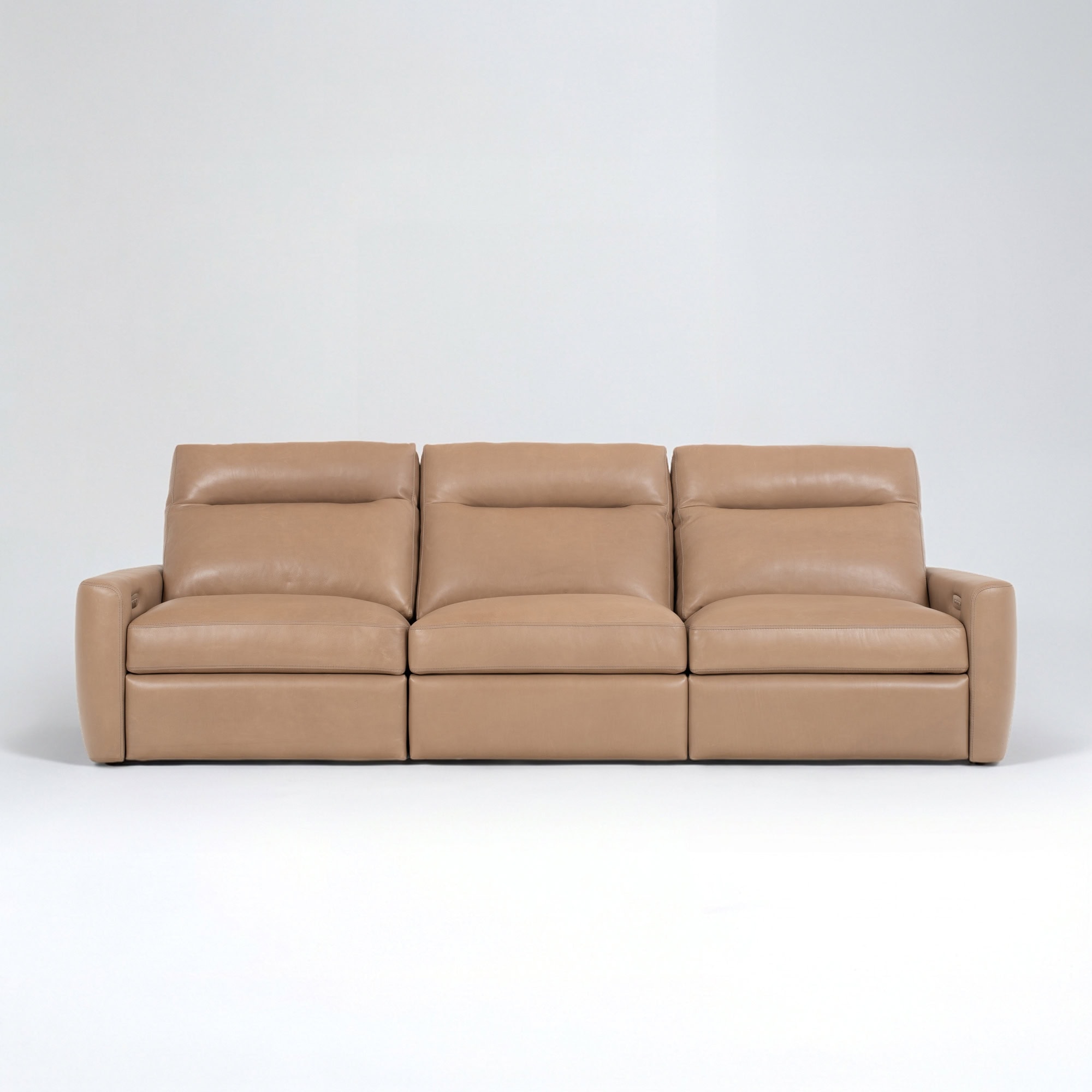 Elegant beige leather sofa with plush cushions for comfortable seating.