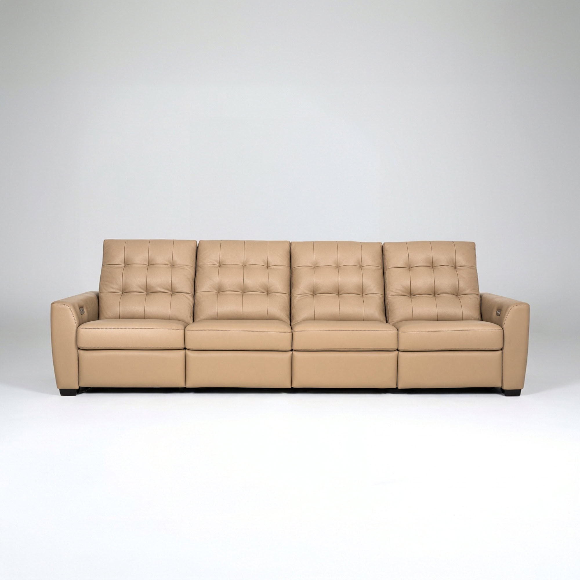 Modern beige sofa with tufted cushions and armrests.