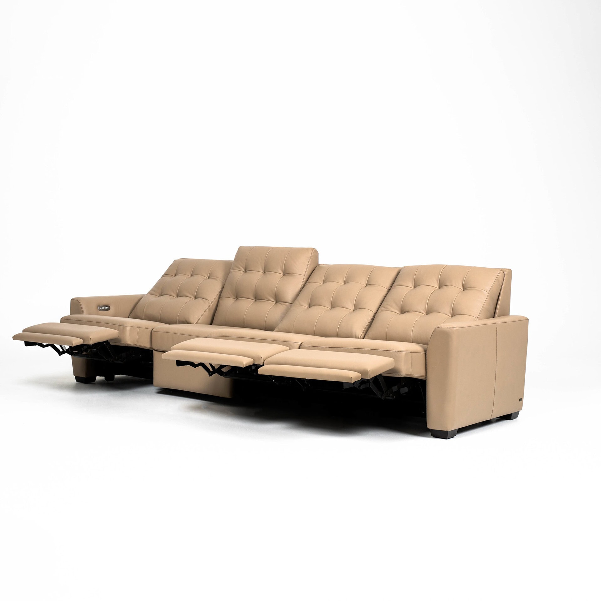 A long, four-seat tan leather reclining sofa with all footrests extended, set against a white background.