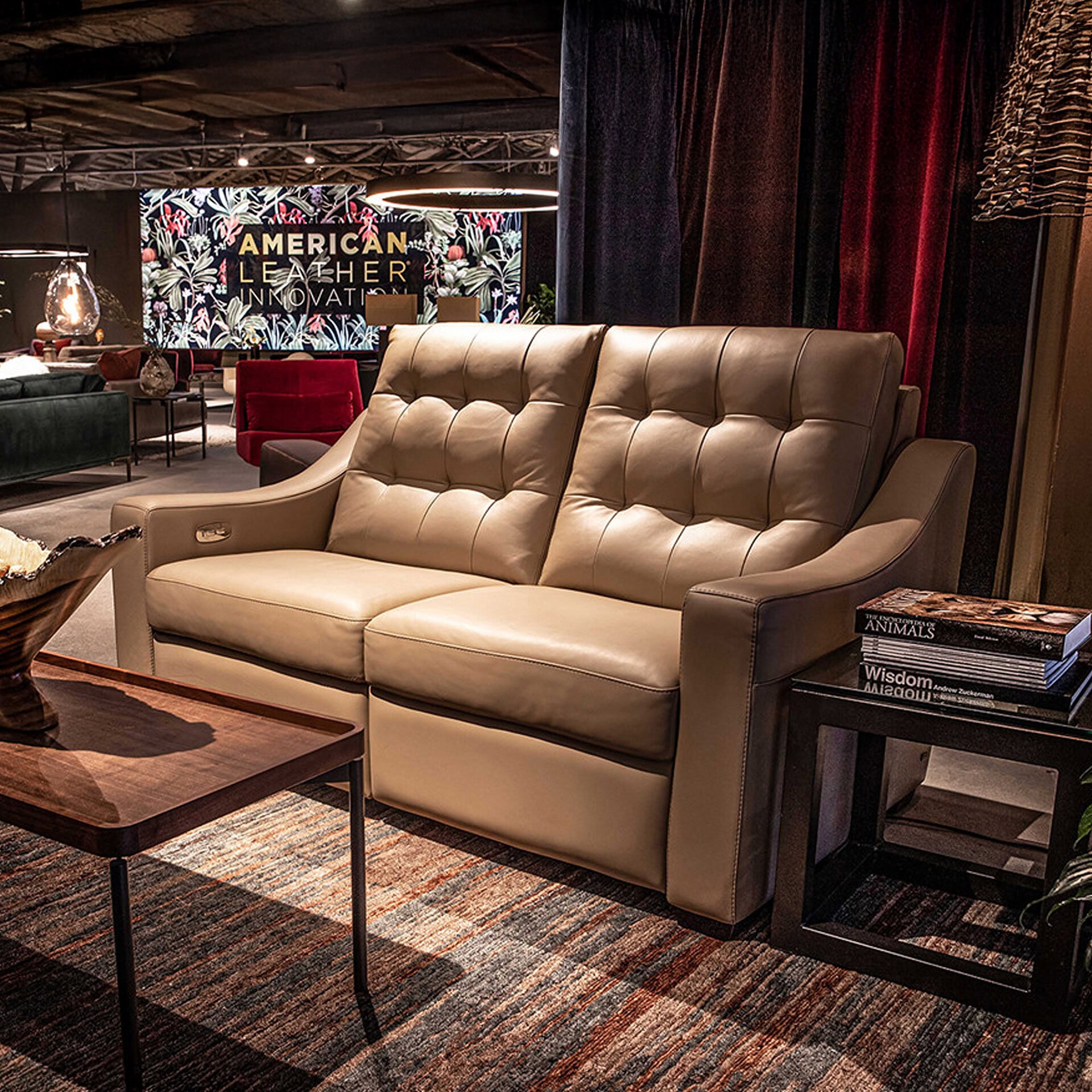 Elegant beige leather sofa with tufted backrest in a stylish living room setting.