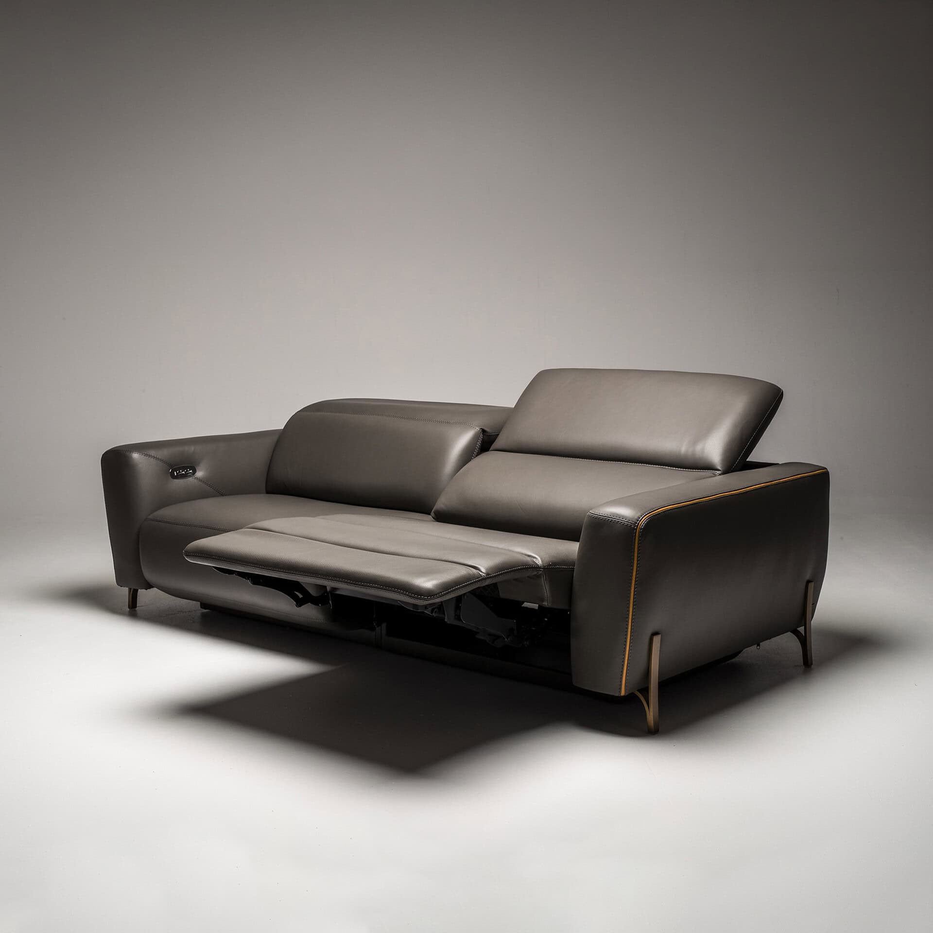 Gray leather sofa with adjustable headrests and contemporary style.