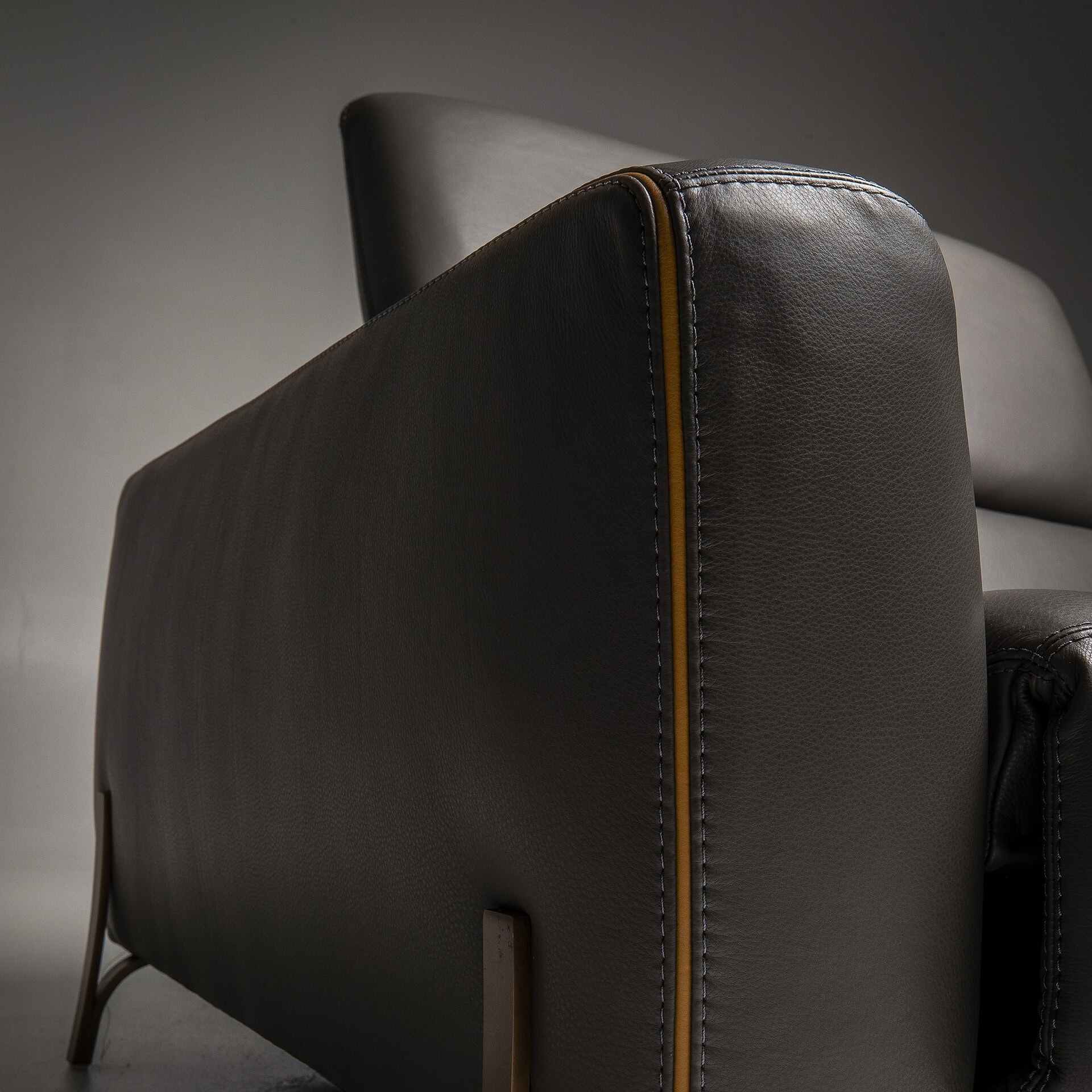 Modern black leather sofa with sleek design and plush cushions.