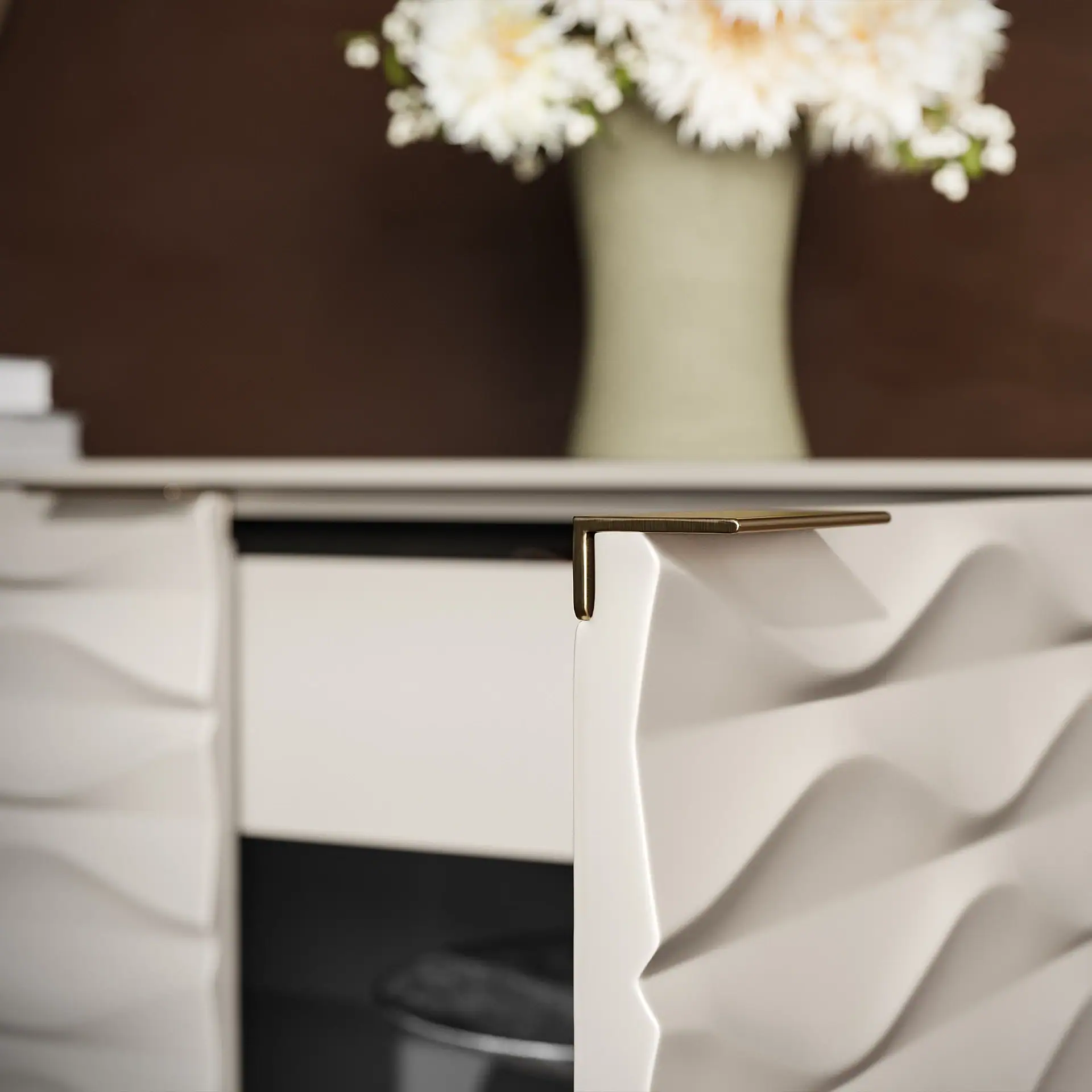 Close-up of Ripple Storage Credenza with textured drawer fronts and gold handle.