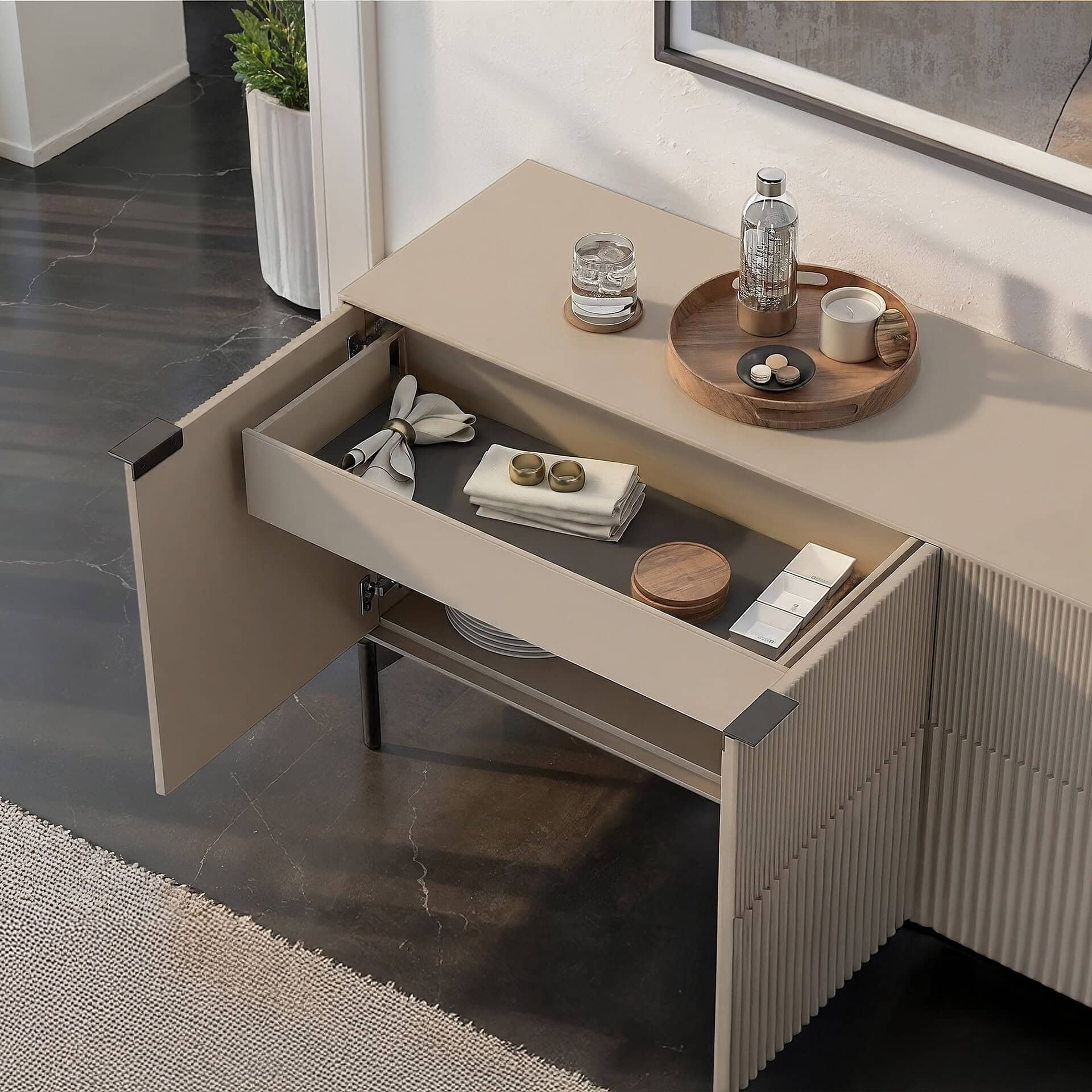 Elegant beige sideboard featuring a drawer with stylish decor and practical storage options.