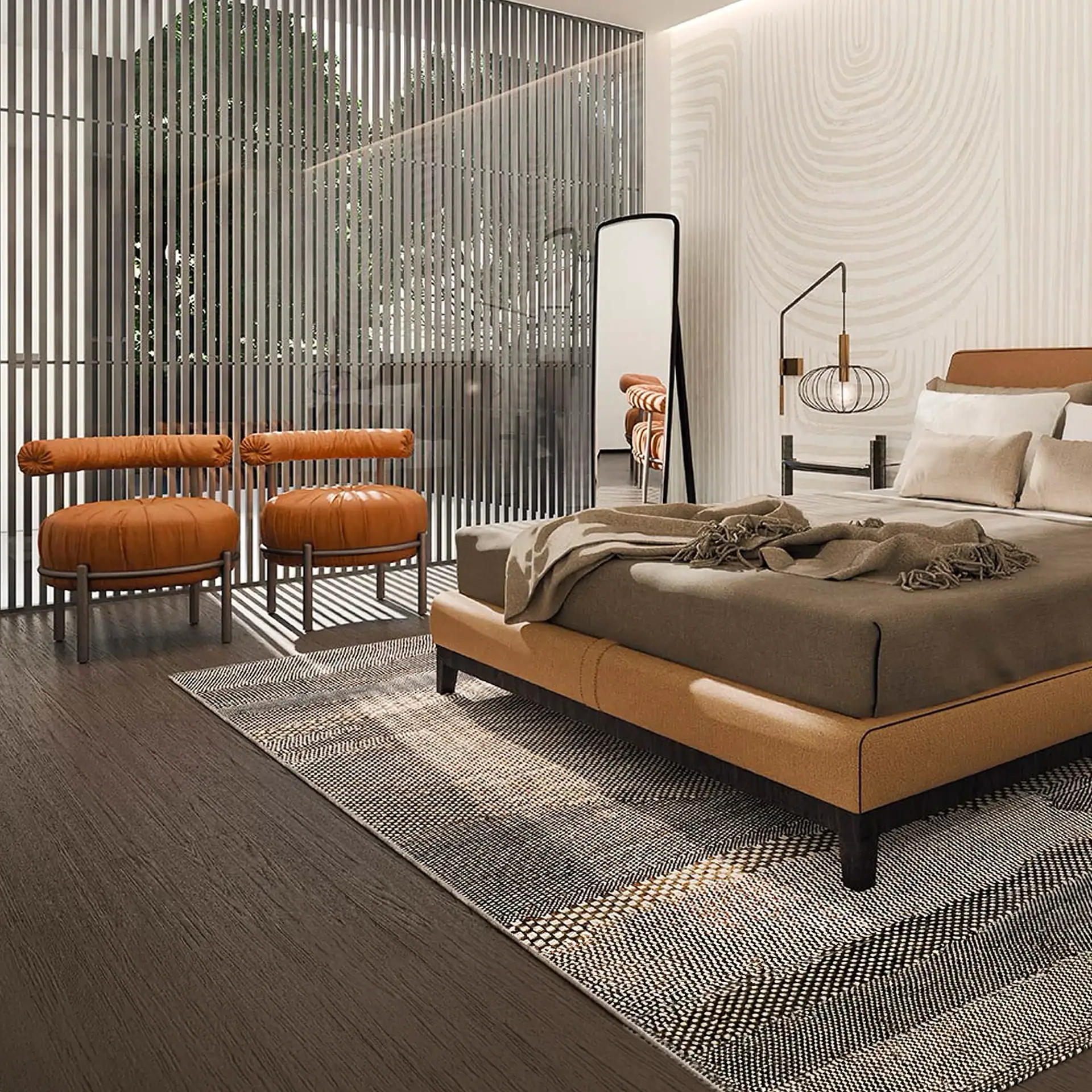A modern bedroom with a tan upholstered bed, two orange leather chairs, a tall mirror, and a geometric rug on a dark wood floor.