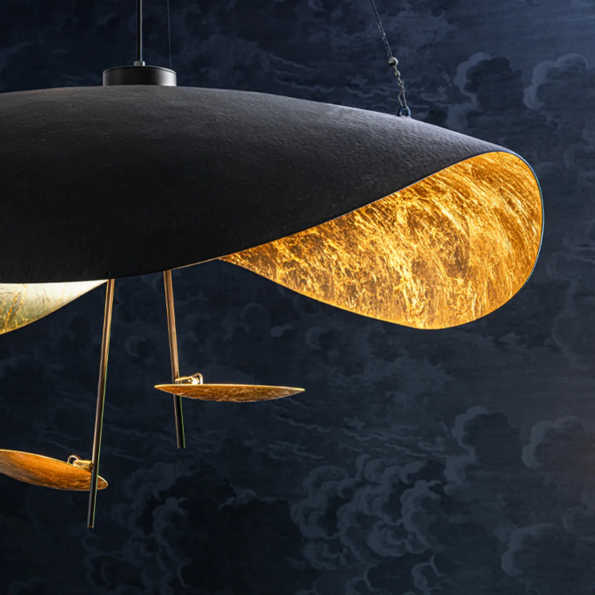Lederam Manta S2 pendant light with black exterior and gold interior.