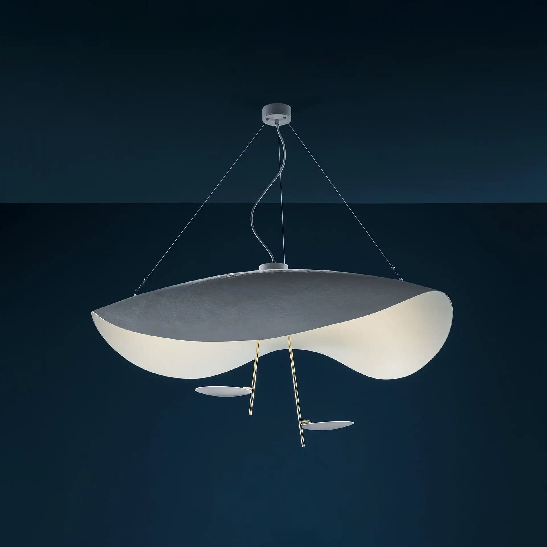 Lederam Manta S2 pendant light hanging from ceiling in a dark room.