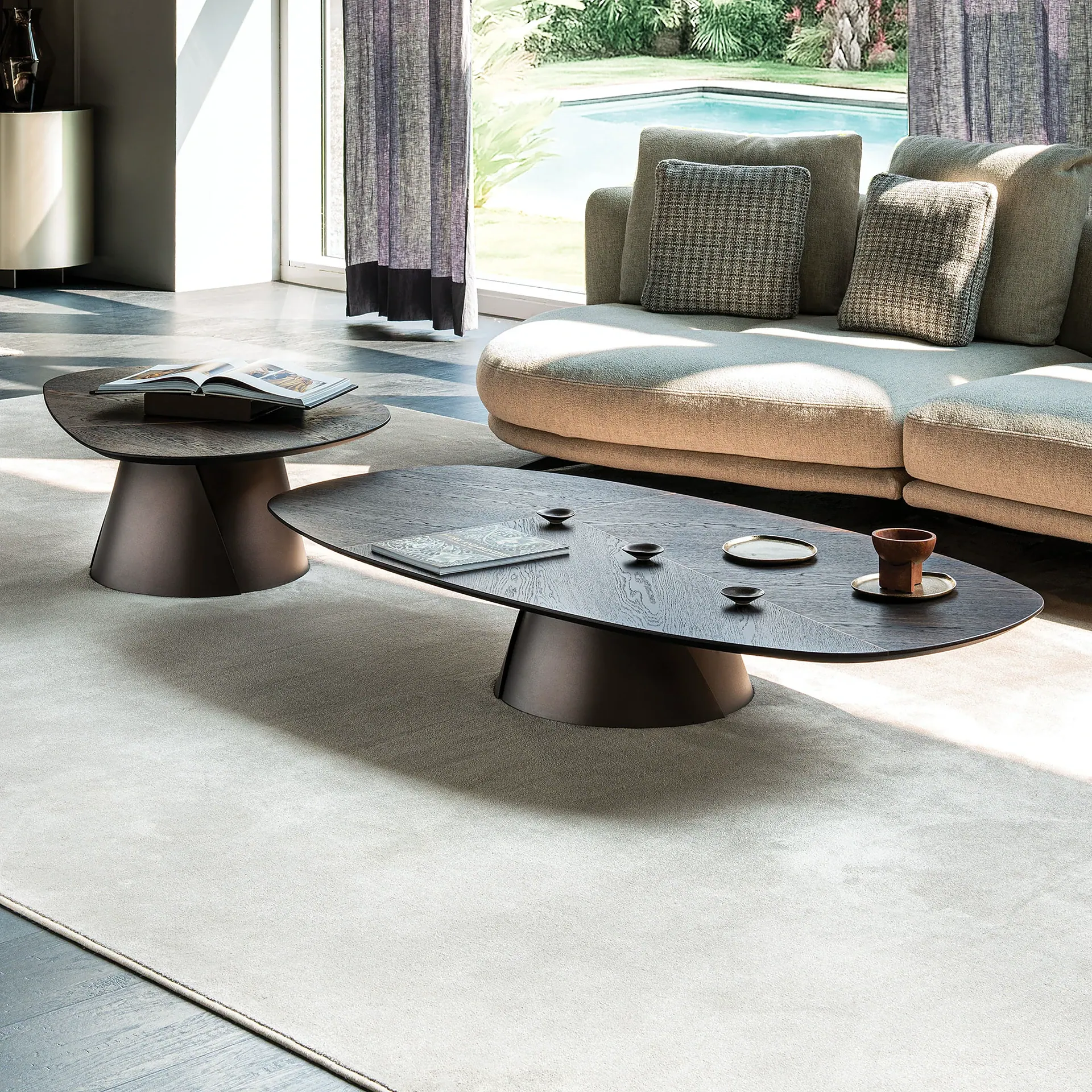 Sklar coffee table set in modern living room by window.