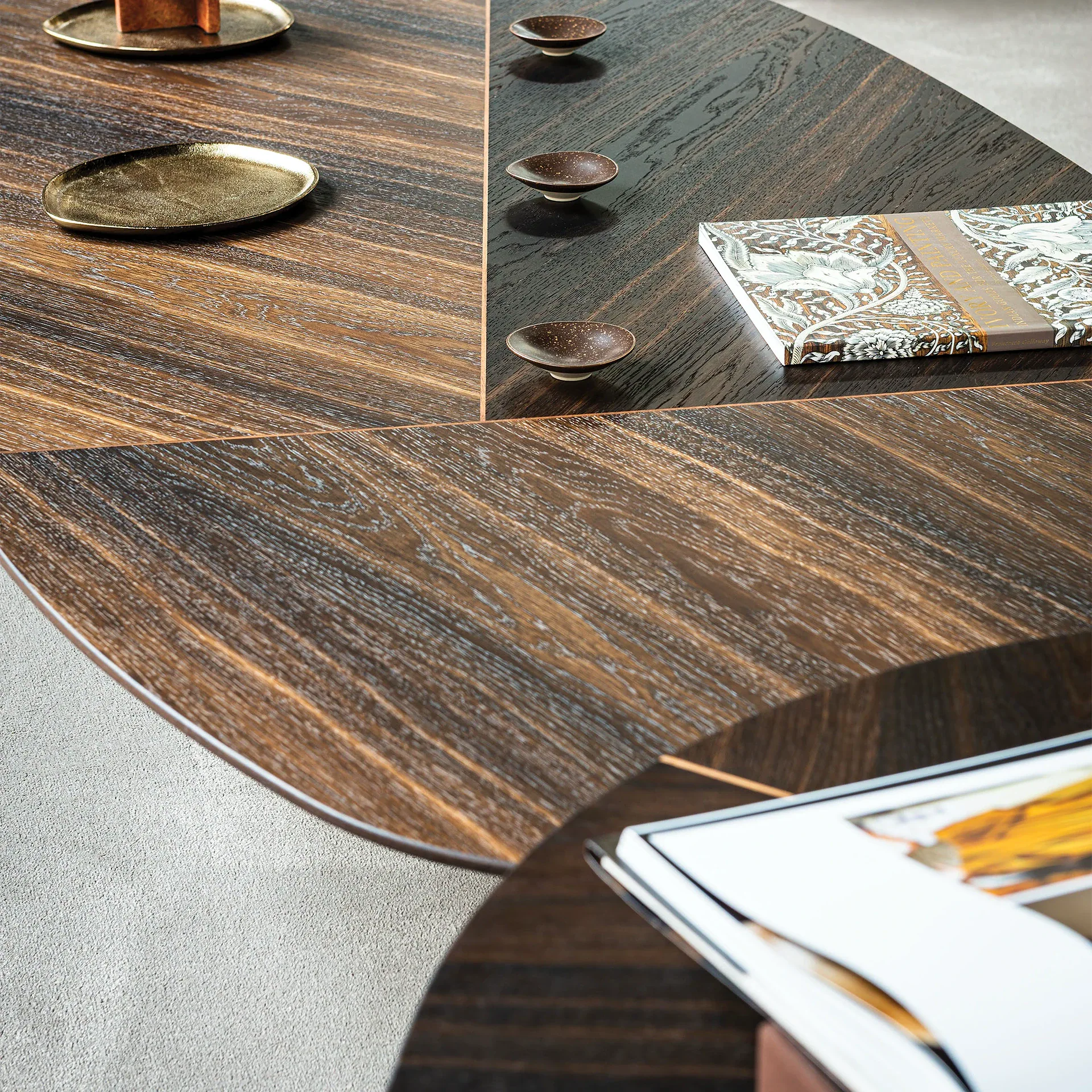 Sklar Furnishings coffee table surface with wood grain and decorative items.