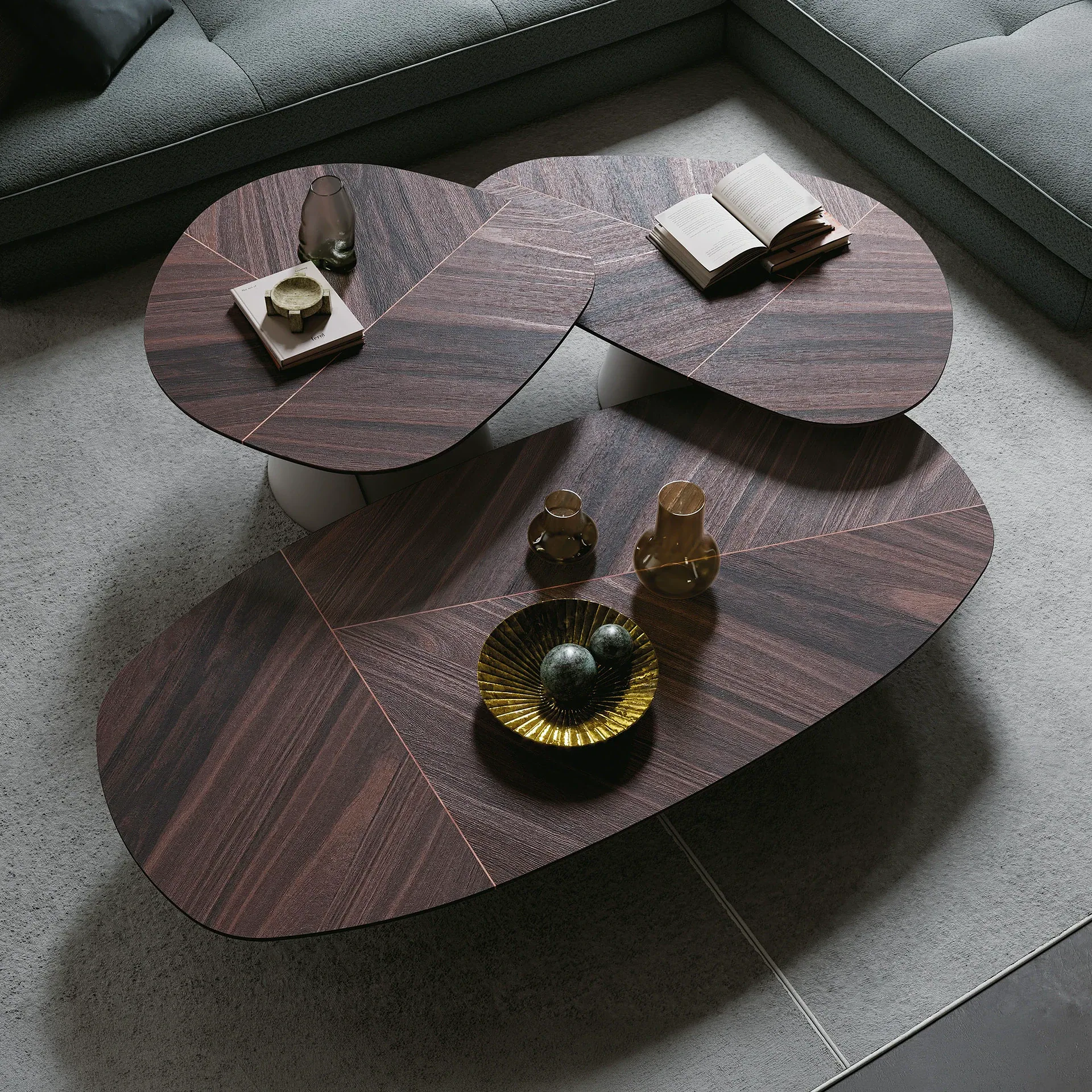 Sklar Furnishings dark wood coffee table set with rounded shapes in a living room.