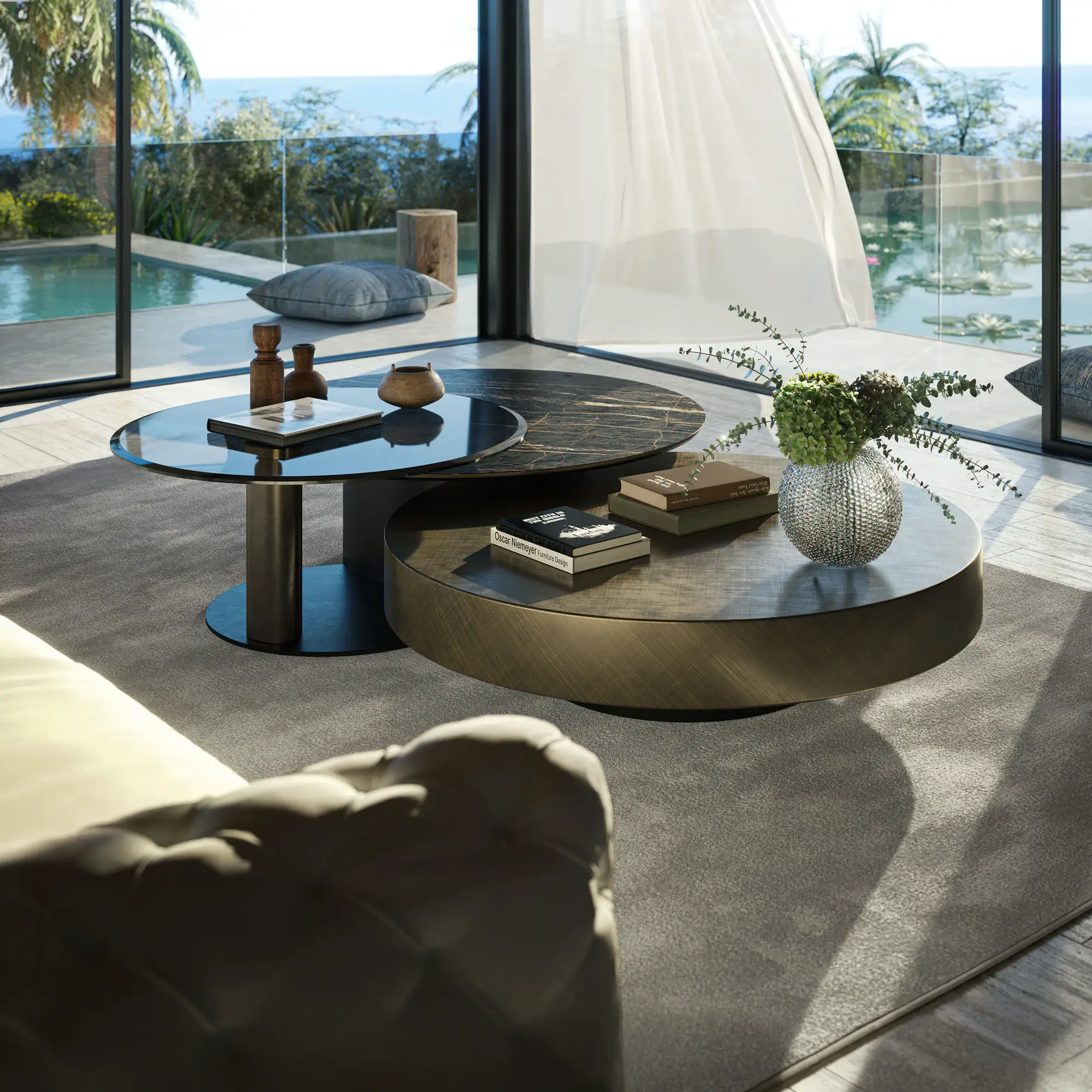 A modern living room with nested coffee tables, a sofa, and a large window overlooking a pool, pond with water lilies, palm trees, and the ocean.
