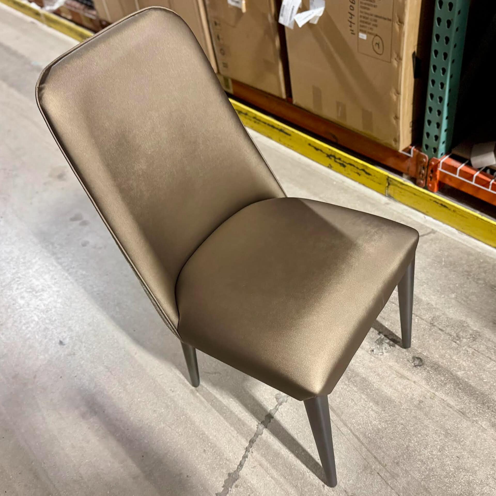 Elegant upholstered dining chair with neutral fabric and stylish design.