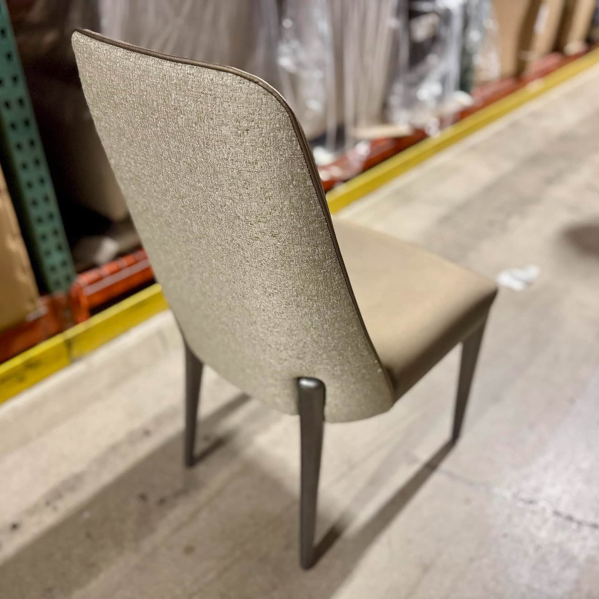 Elegant beige upholstered dining chair with dark wooden legs, ideal for contemporary dining rooms.