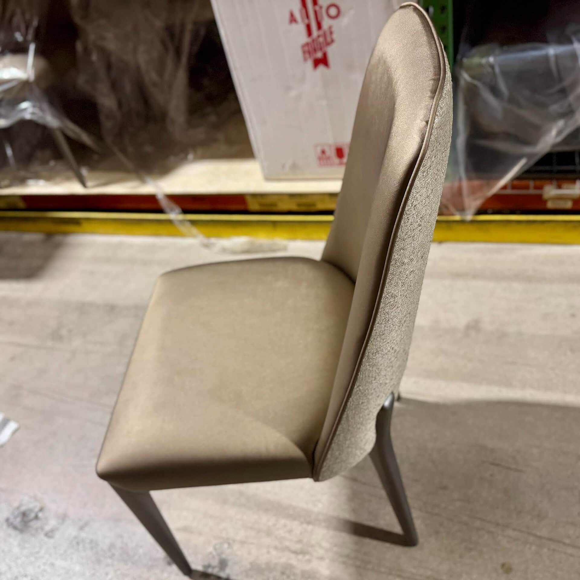 Elegant beige upholstered dining chair with wooden legs, perfect for contemporary dining rooms.