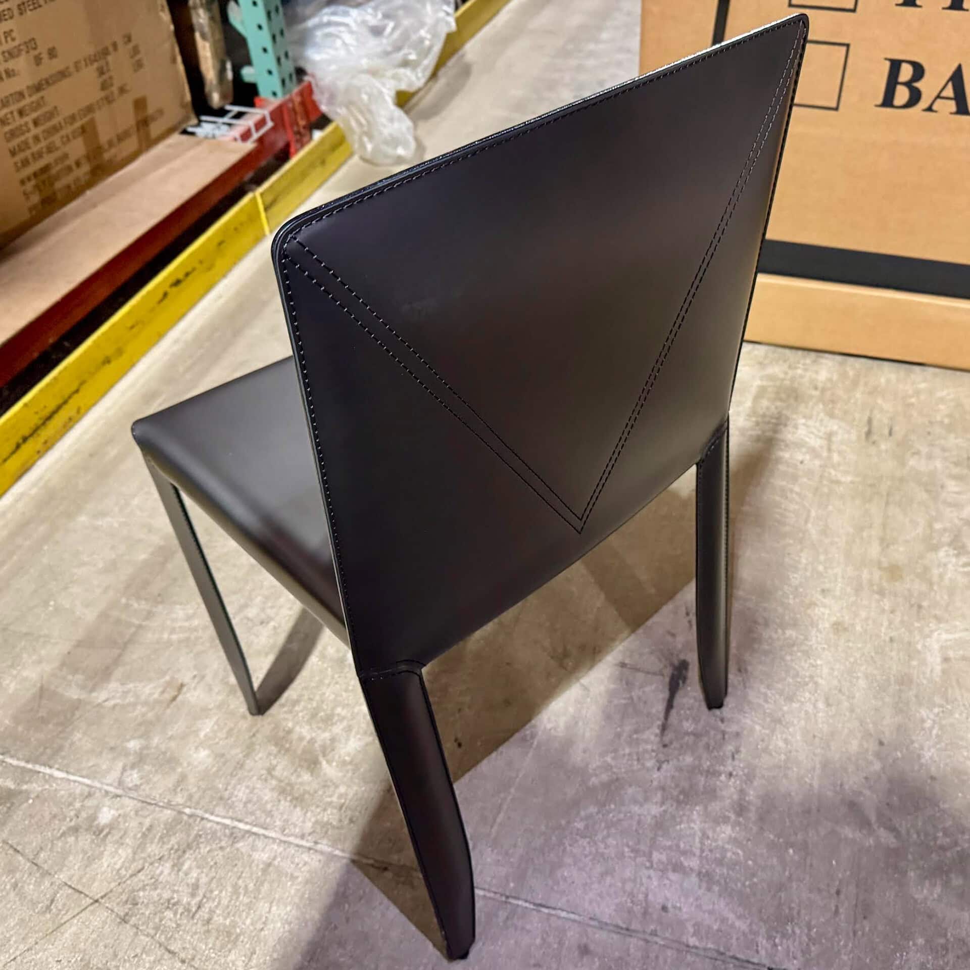 Black upholstered dining chair with sleek design and sturdy metal legs.