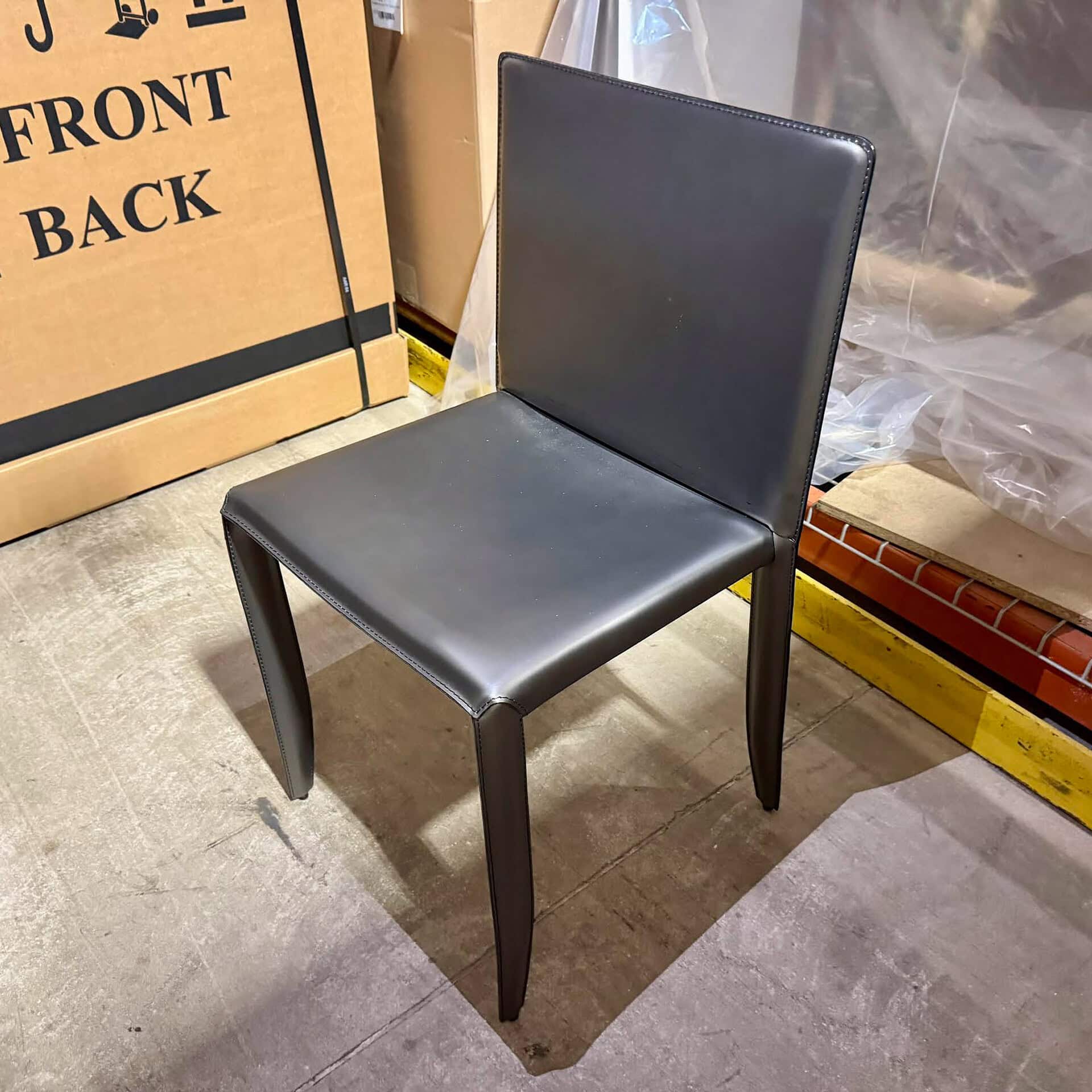 Black upholstered dining chair with sleek design and sturdy wooden legs.