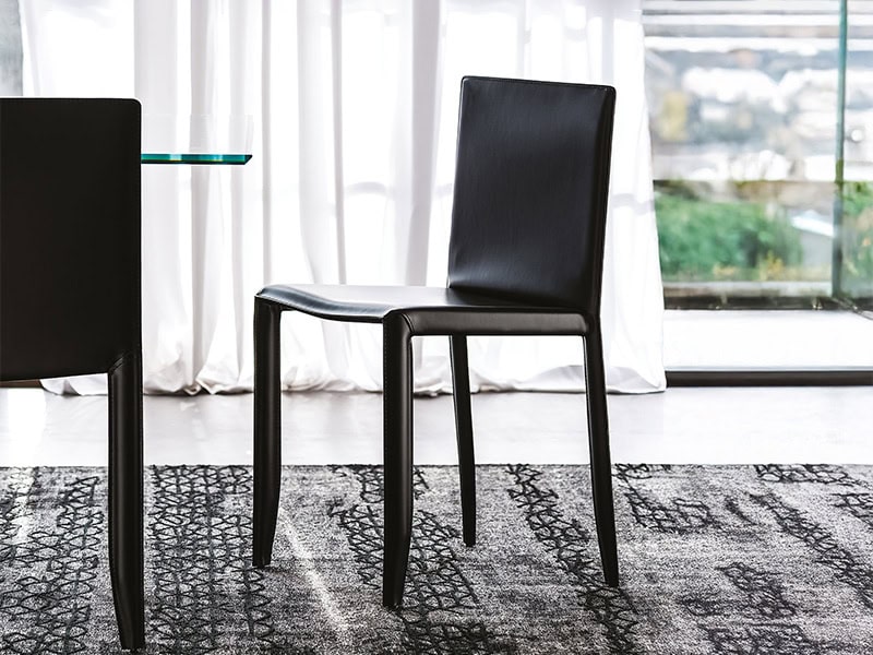 Black dining chair with sleek design and comfortable upholstery. Perfect for contemporary dining roo.