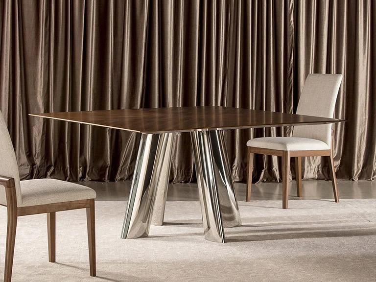 Elegant round dining table with a distinctive metallic base in a stylish dining room.