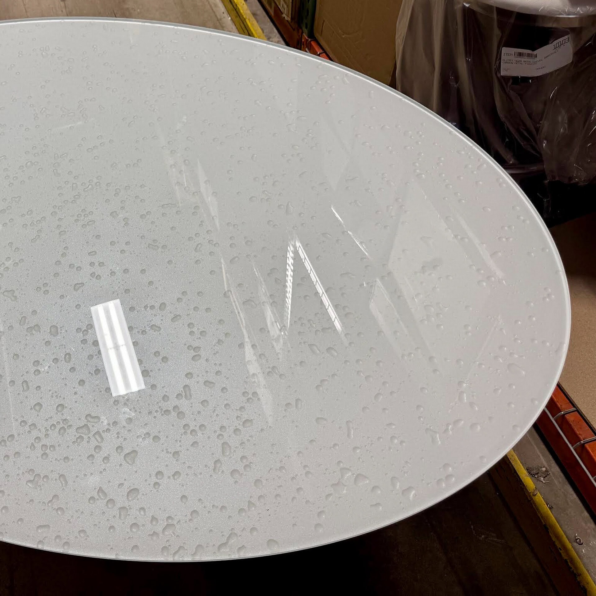 Modern glass coffee table with water droplets, sleek design for contemporary living rooms.